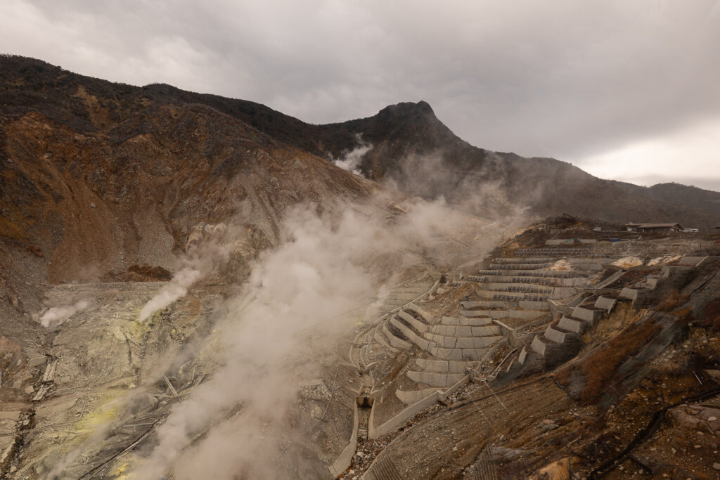 Aerial view of Owakudani’s steaming volcanic valley seen from the Hakone Ropeway.