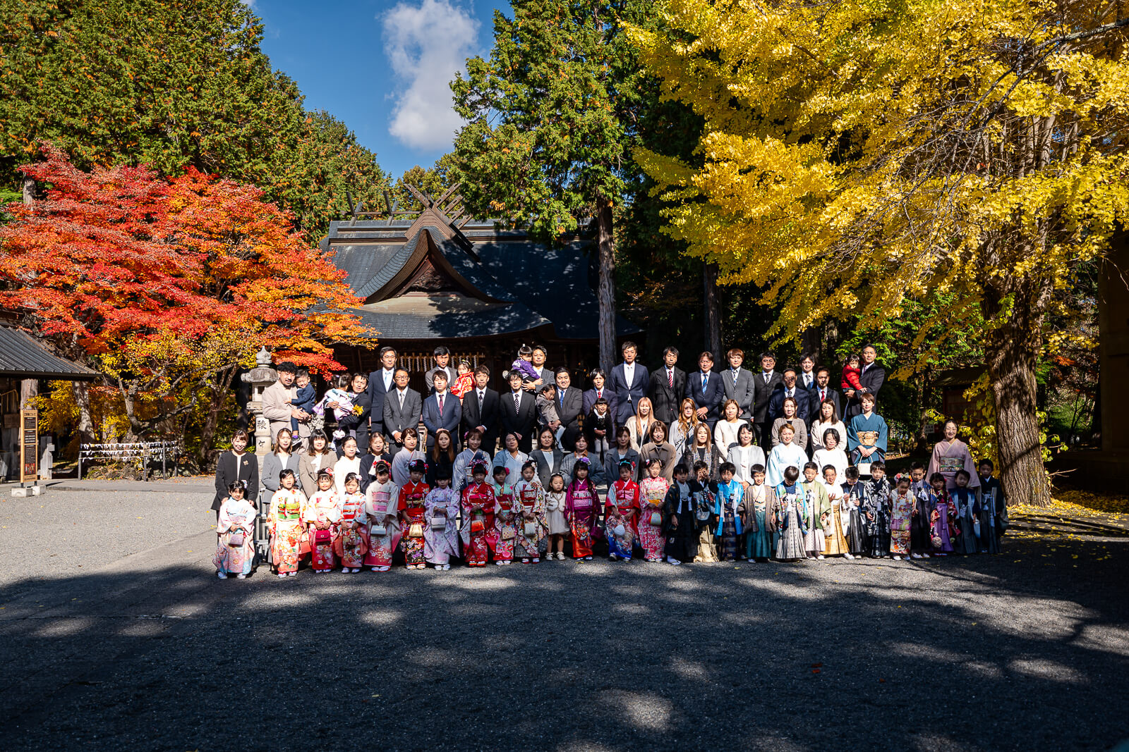 Group gathered beneath the ginkgo in the courtyard at Fuji Omuro Sengen Shrine