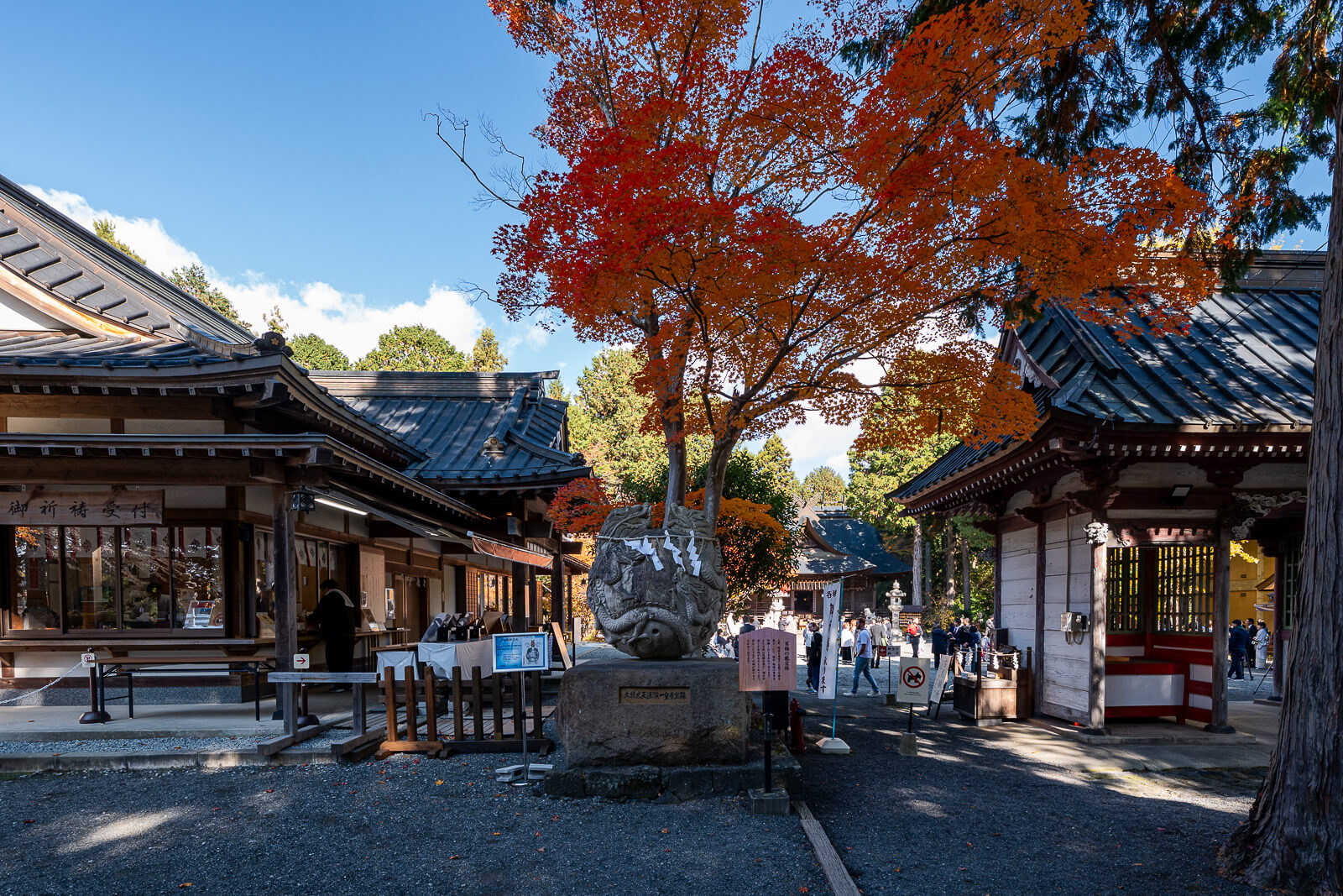 Round carved stone and courtyard administration window at Fuji Omuro Sengen Shrine