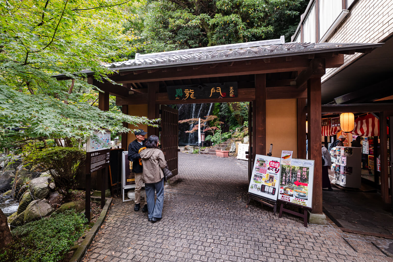 Public entrance to Tenseien Garden in Hakone-Yumoto beside trees and the hotel property.
