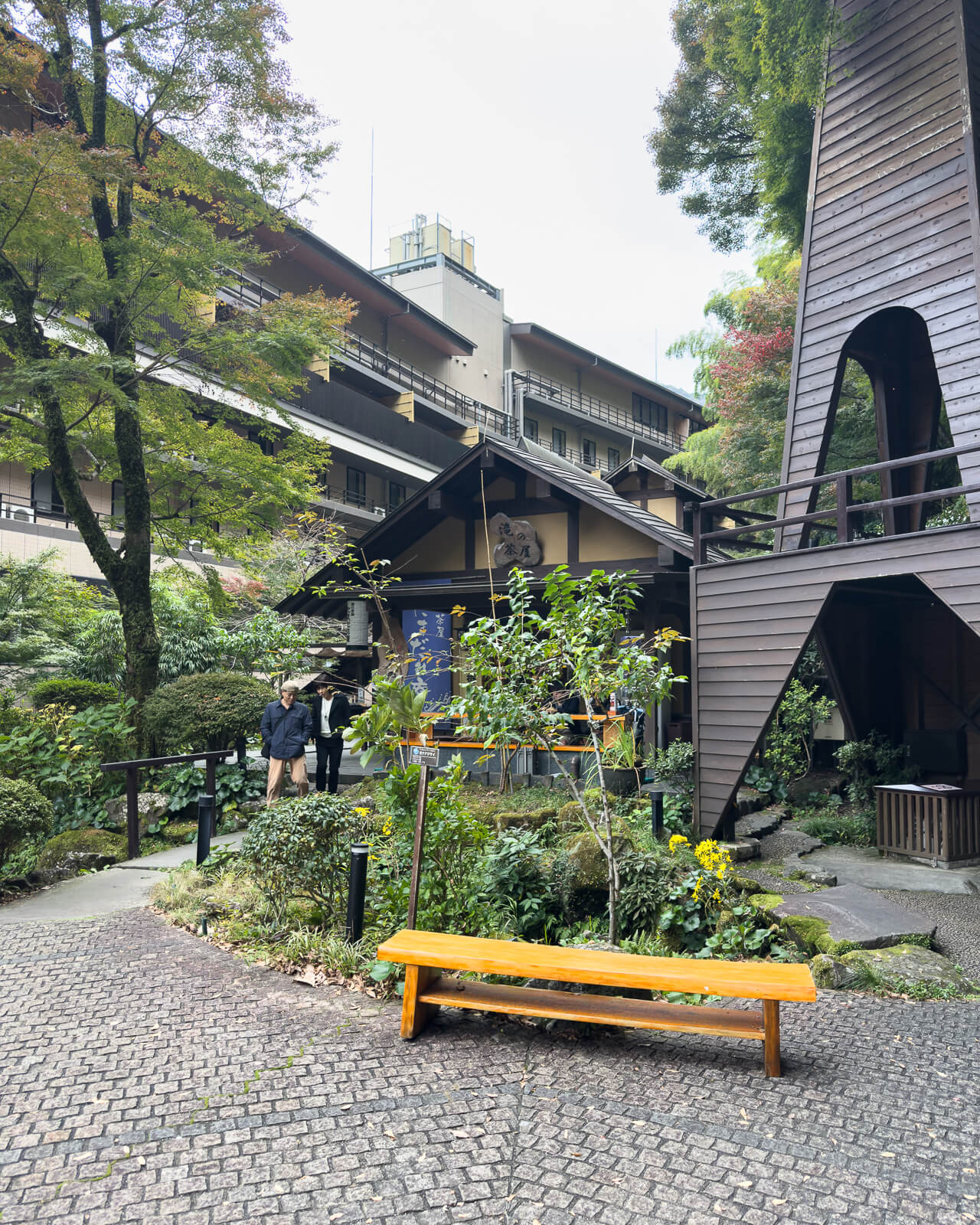 Covered seating area beside the landscaped garden path at Tenseien in Hakone-Yumoto.