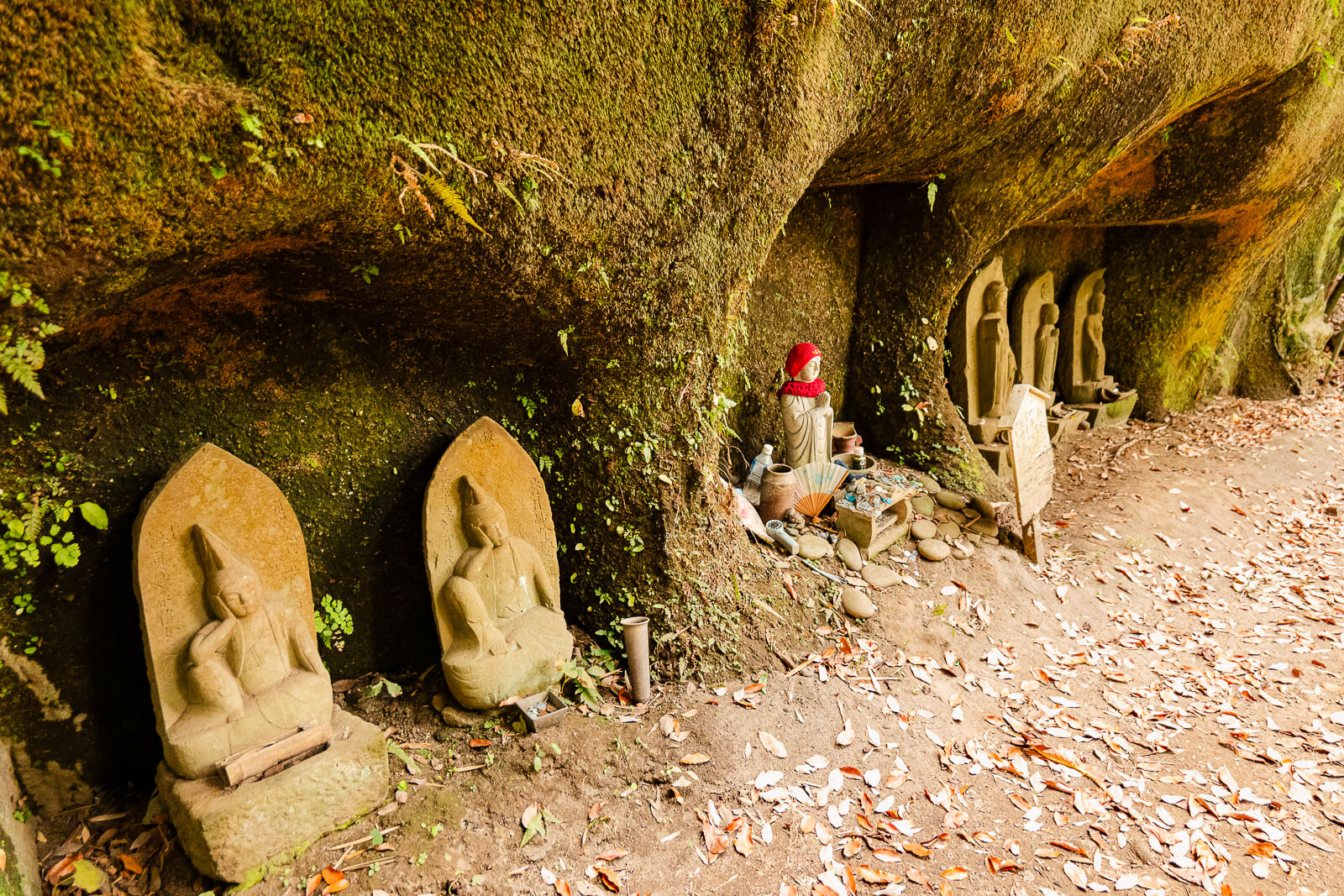 Stone Buddhist statues beside the yagura rock-cut tombs at Jōchi-ji Temple