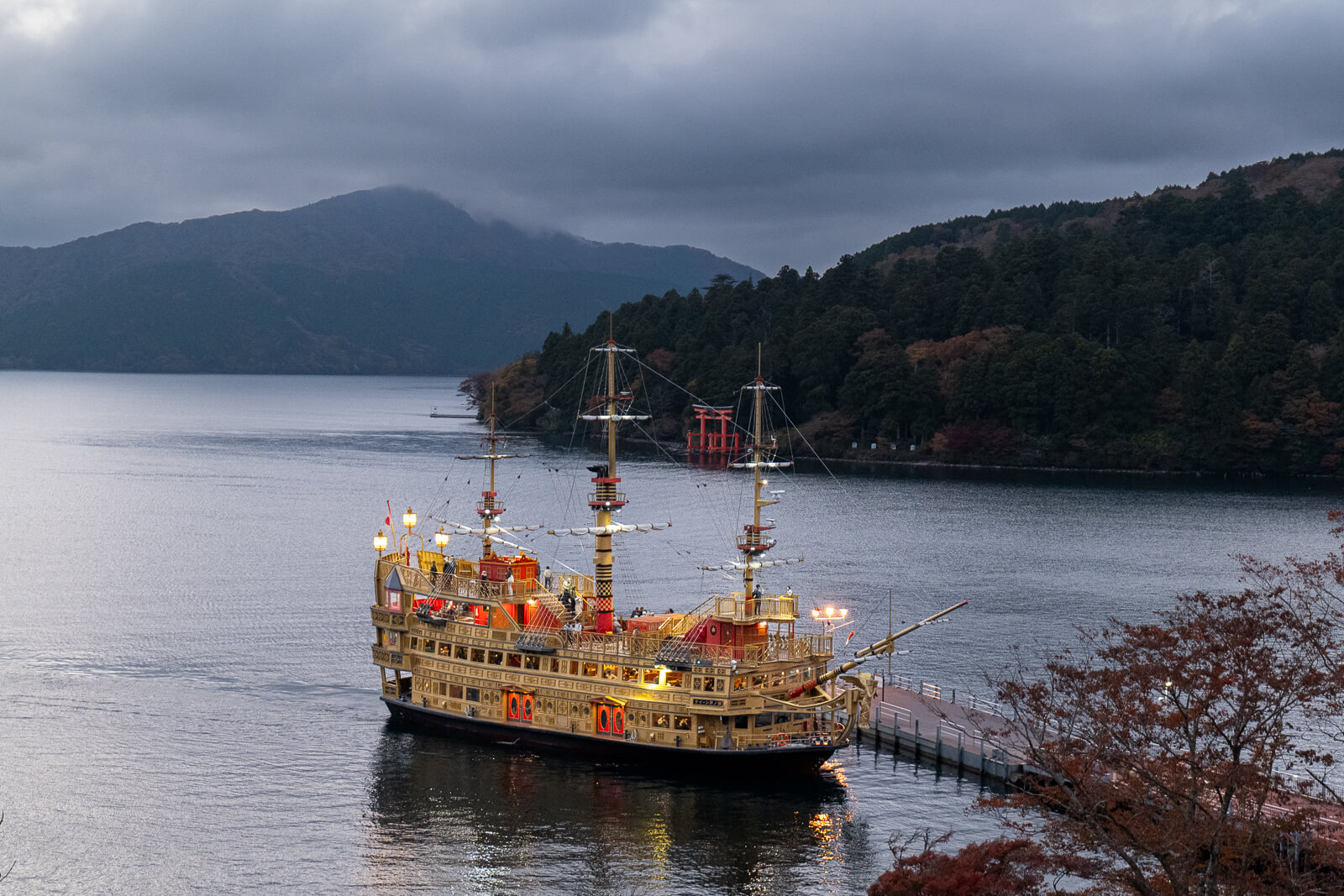 Sightseeing boat on Lake Ashi viewed from the garden terrace at Narukawa Art Museum