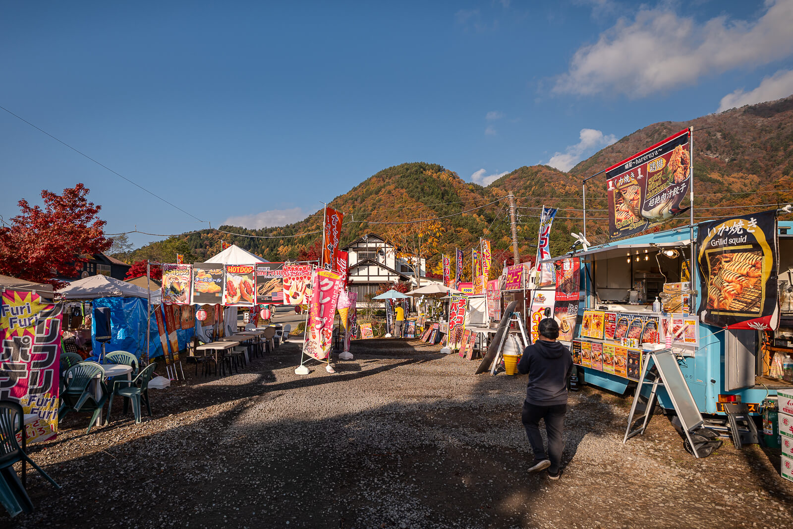 Food trucks and visitors along the vendor lane at Kawaguchiko Maple Corridor area