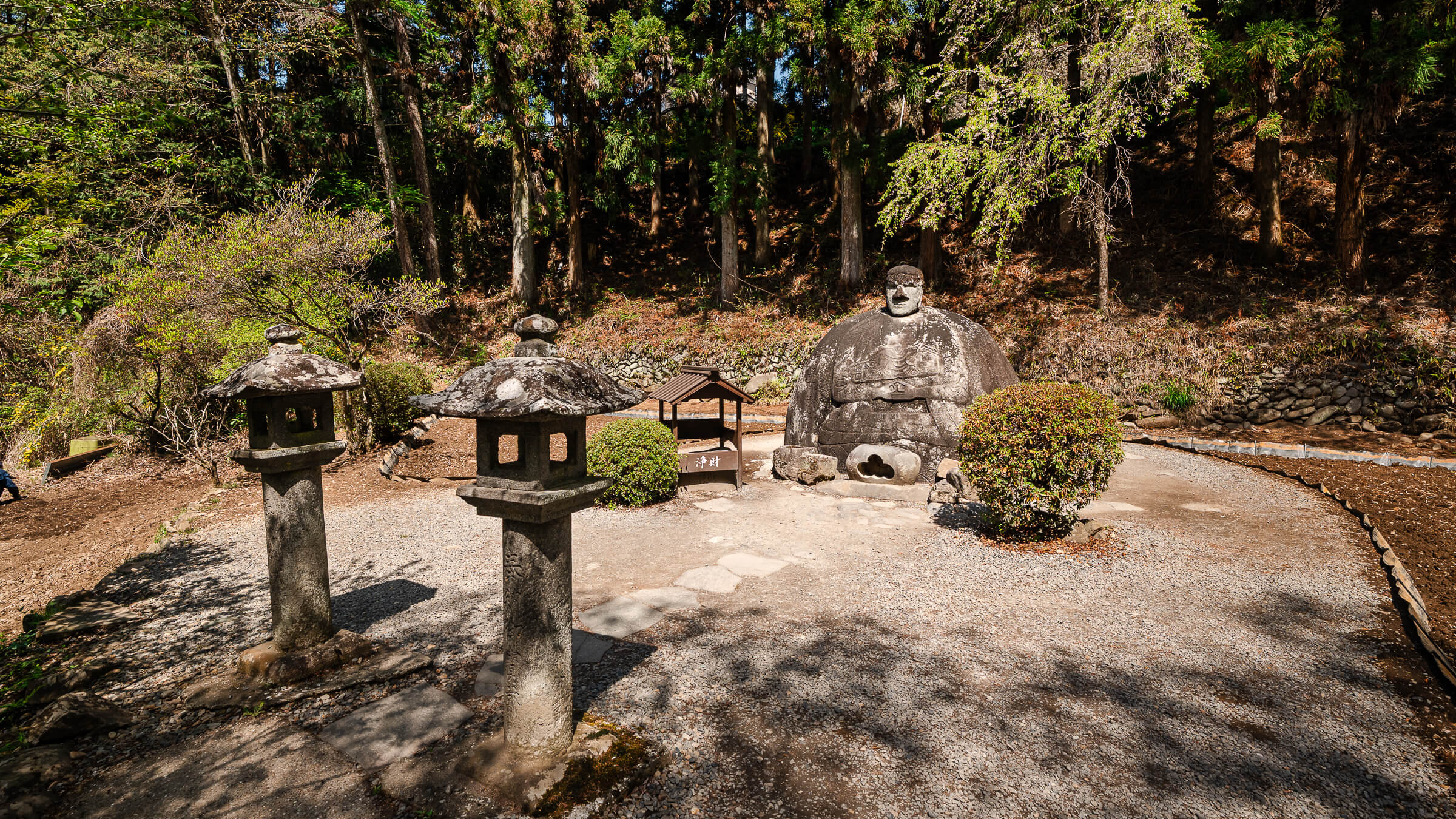 Manji Stone Buddha next to the to river in shimosuwa nagano