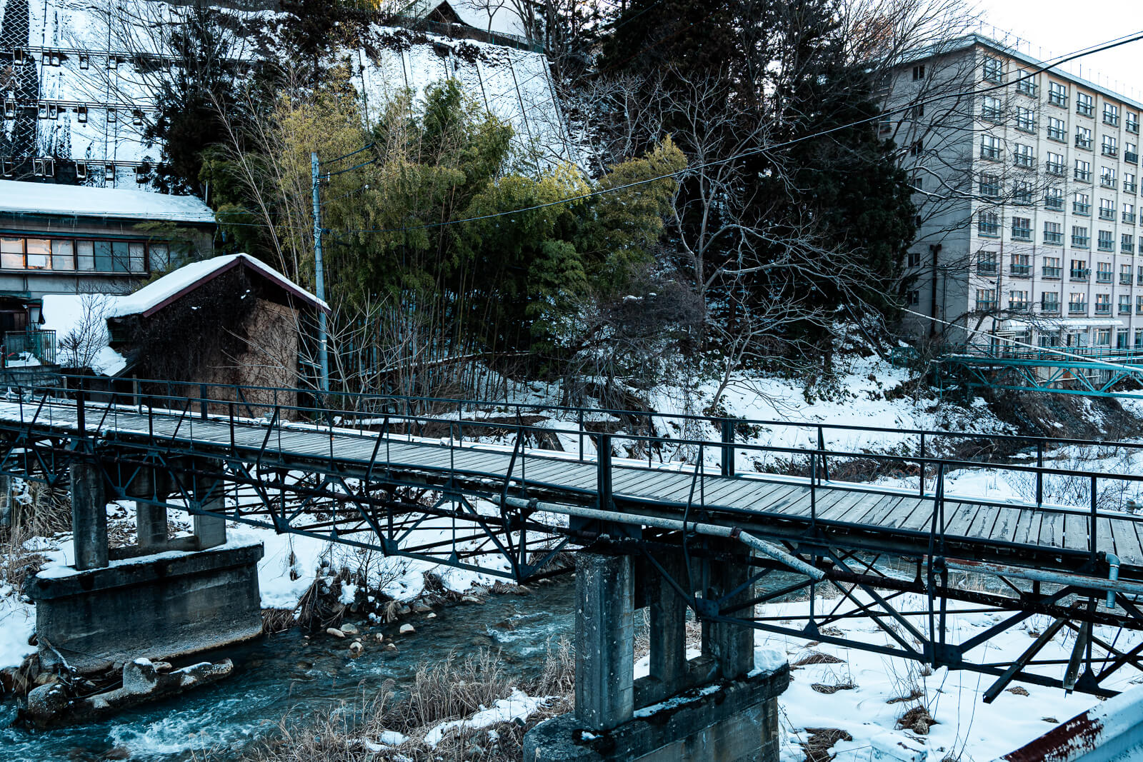 Snow-covered bridge and wooden structures at Shibu Onsen, Yamanouchi