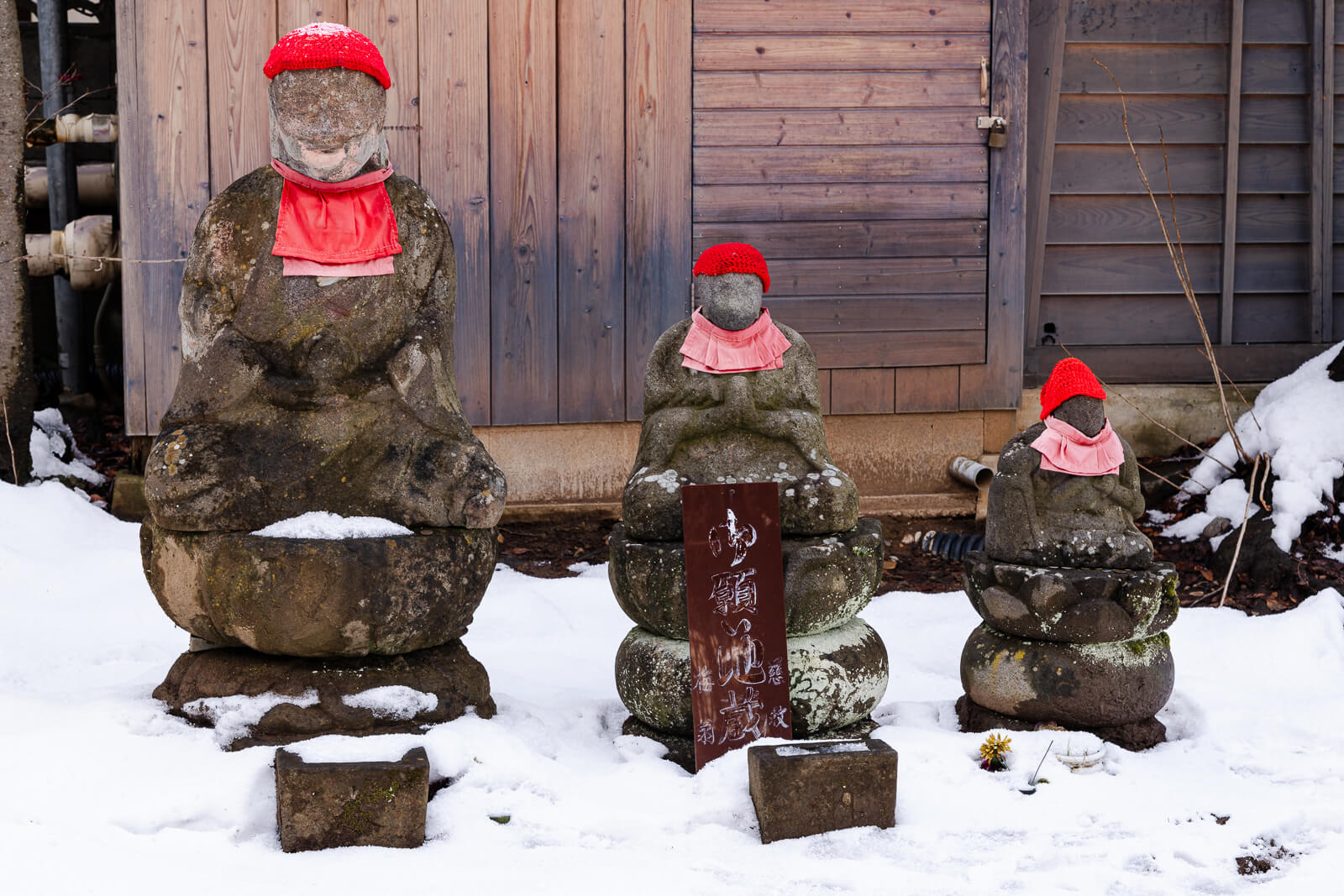 Small Jizo statues with red caps at Baio-ji Temple, Nagano