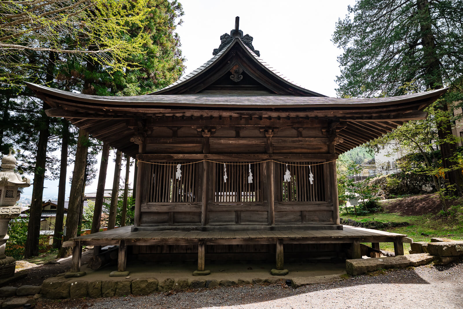 Front view of the Jukkenro hall at Suwa Taisha Kamisha Maemiya surrounded by forest