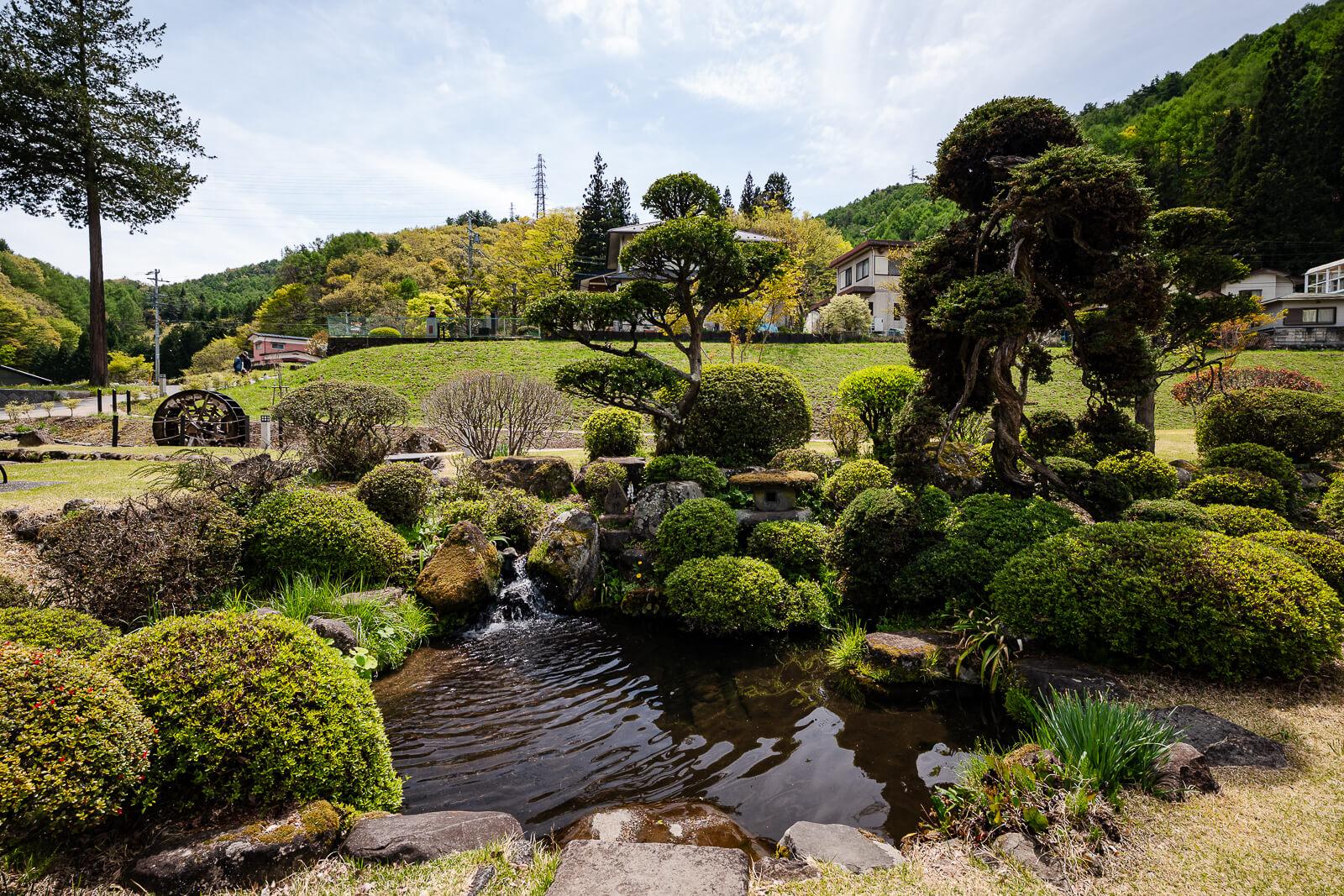 Suigan water garden area at Suwa Taisha Kamisha Maemiya surrounded by greenery and flowing water