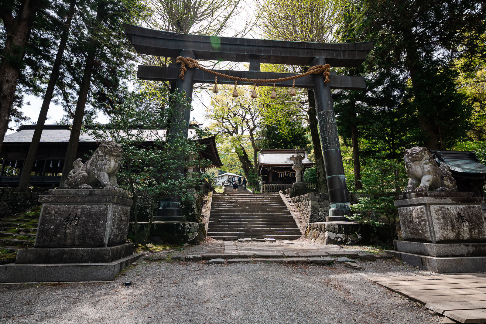 Second torii gate at Suwa Taisha Kamisha Maemiya surrounded by forest in Chino near Lake Suwa