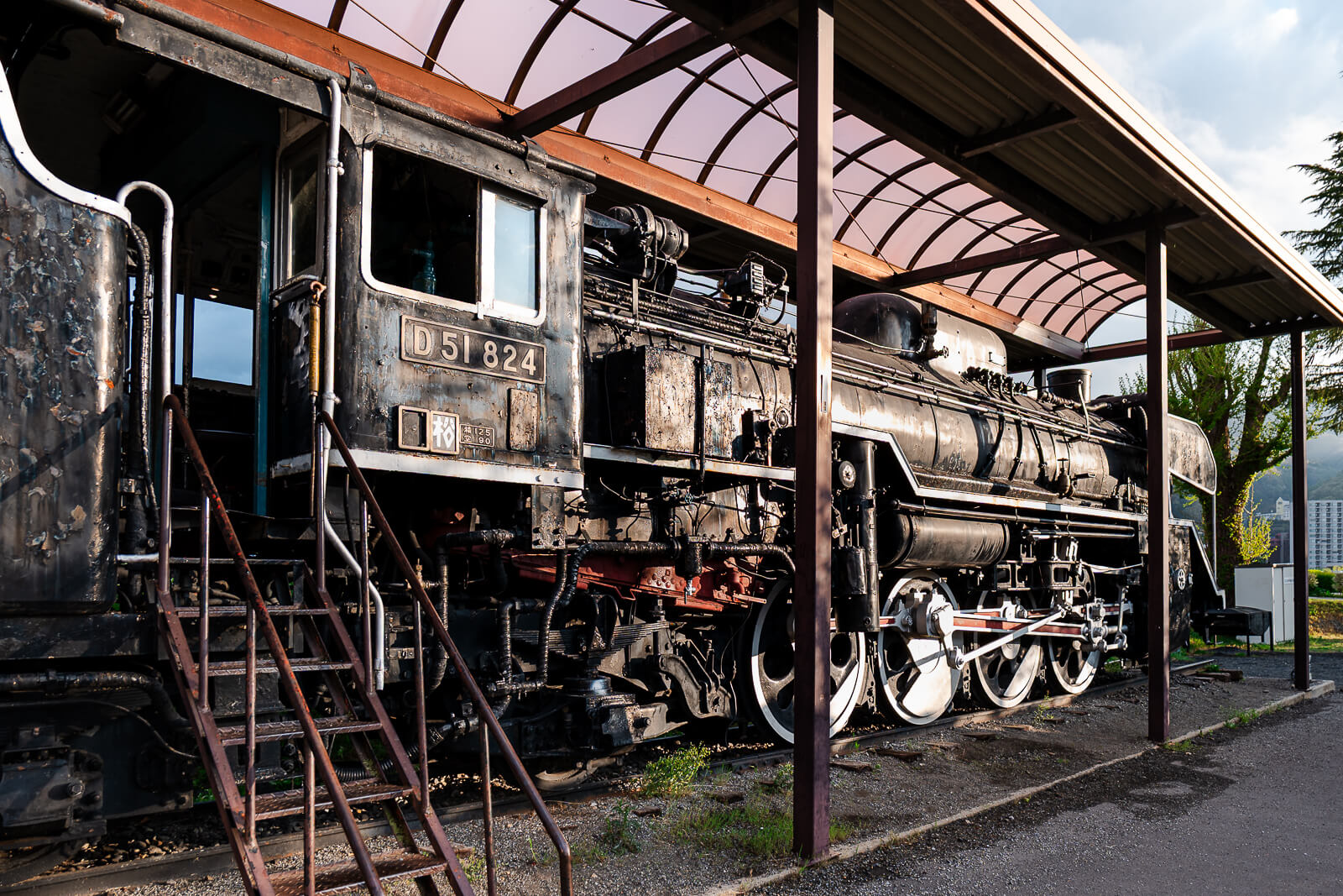 Covered steam locomotive display at lakeside park