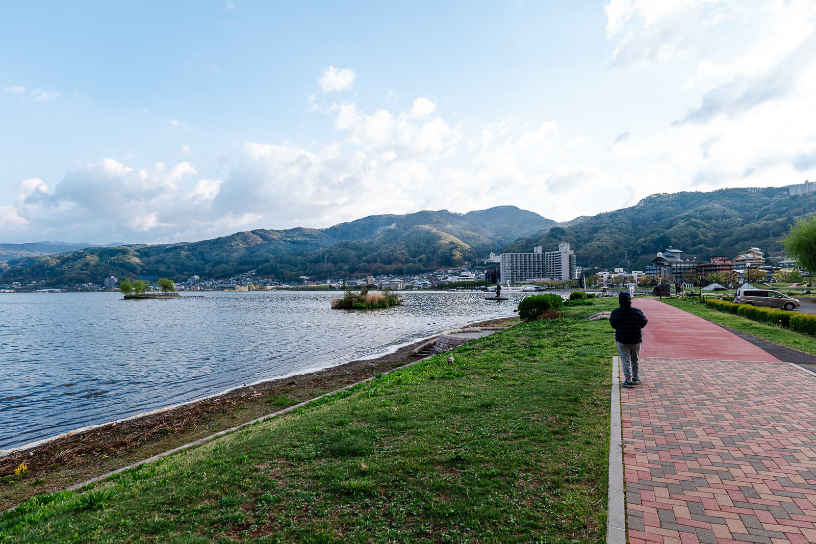 Lakeside path with continuous shoreline and mountains