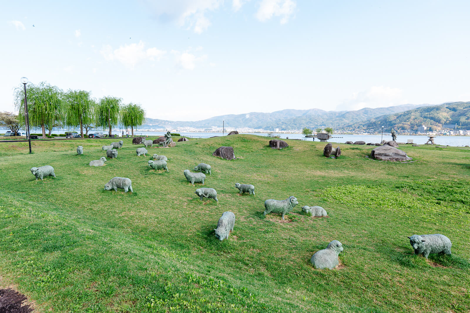 Open field with scattered sculptures at Suwa Lakeside Park