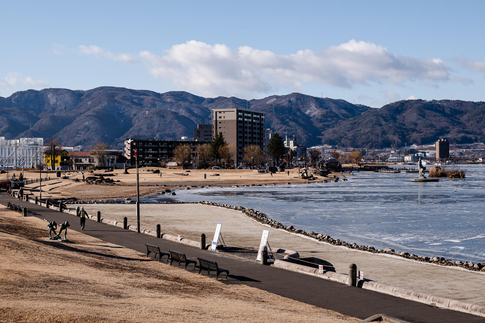 Wide shoreline view opening onto Lake Suwa from Sekicho Park