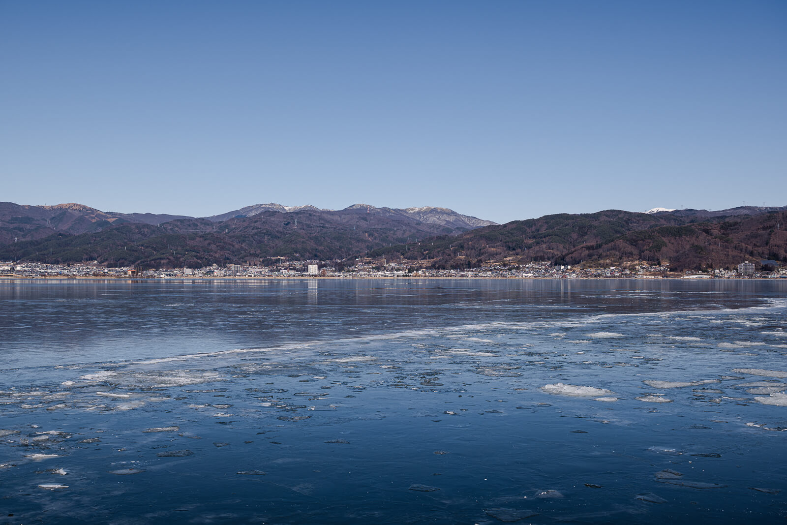 A view of frozen Lake Suwa in winter in Nagaon