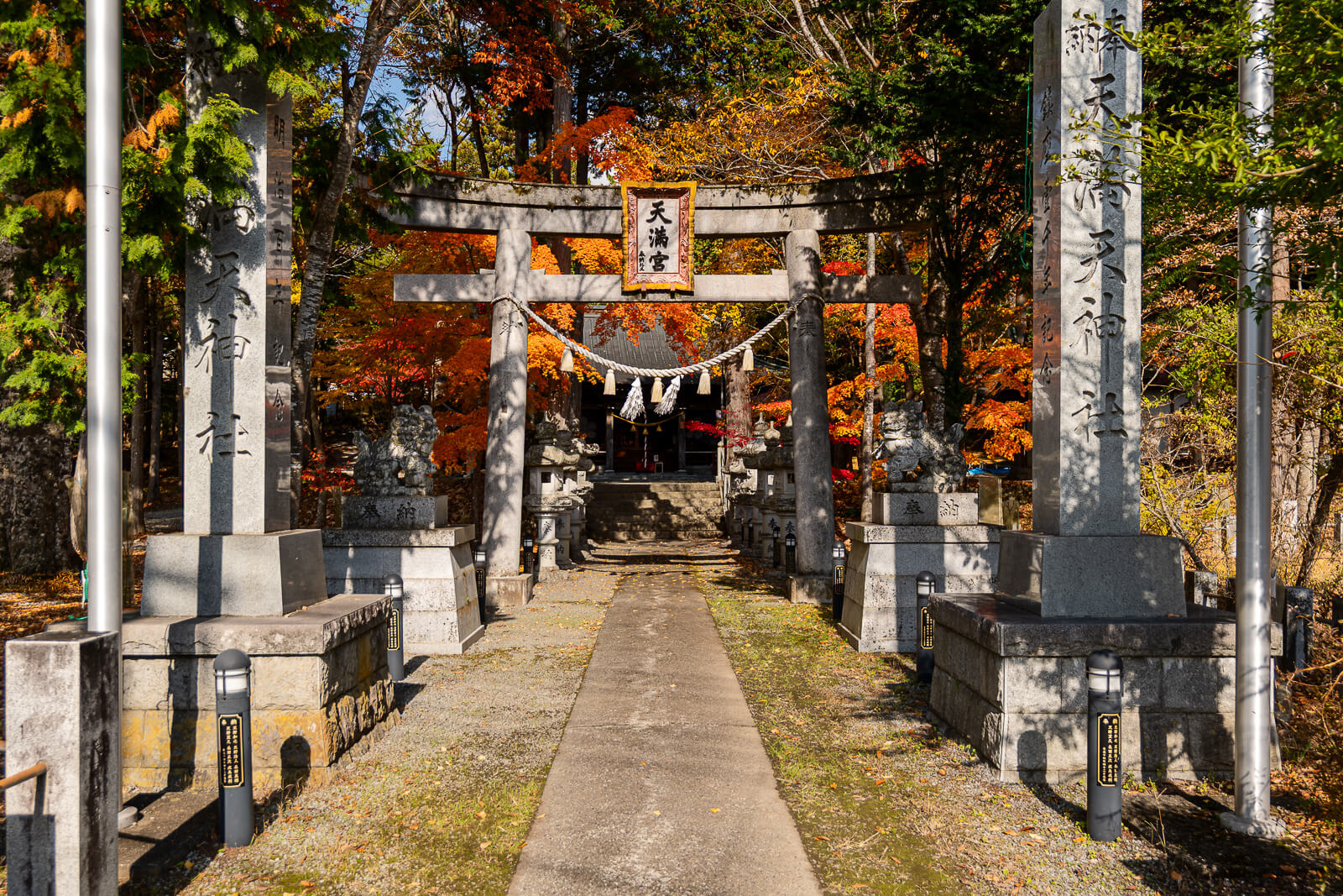 Wide street entrance and stone pillars at Hirano Tenmangu