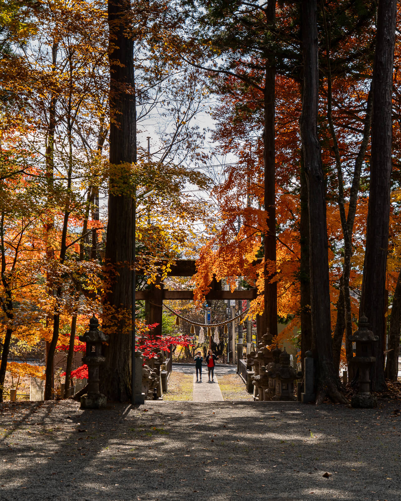 Portrait reverse view with visitors on the path at Hirano Tenmangu