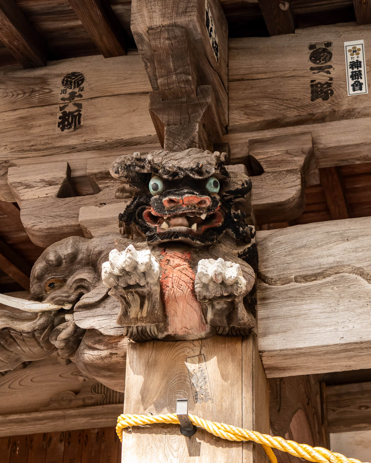 Close portrait of a wooden guardian carving at Hirano Tenmangu