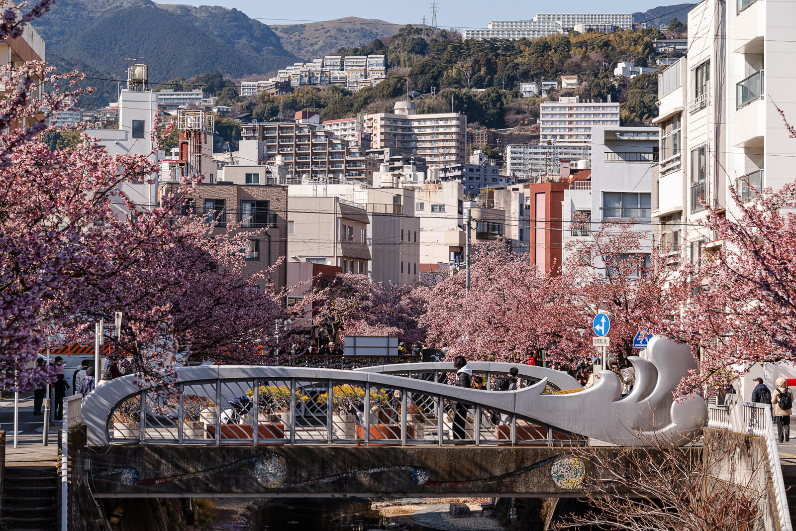 Stone bridge crossing the Itokawa River promenade in Atami