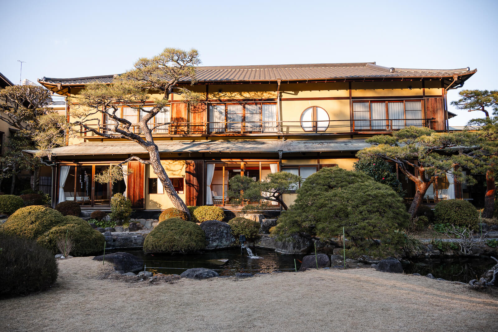 Exterior view of Kiunkaku historic villa building and garden pond in Atami