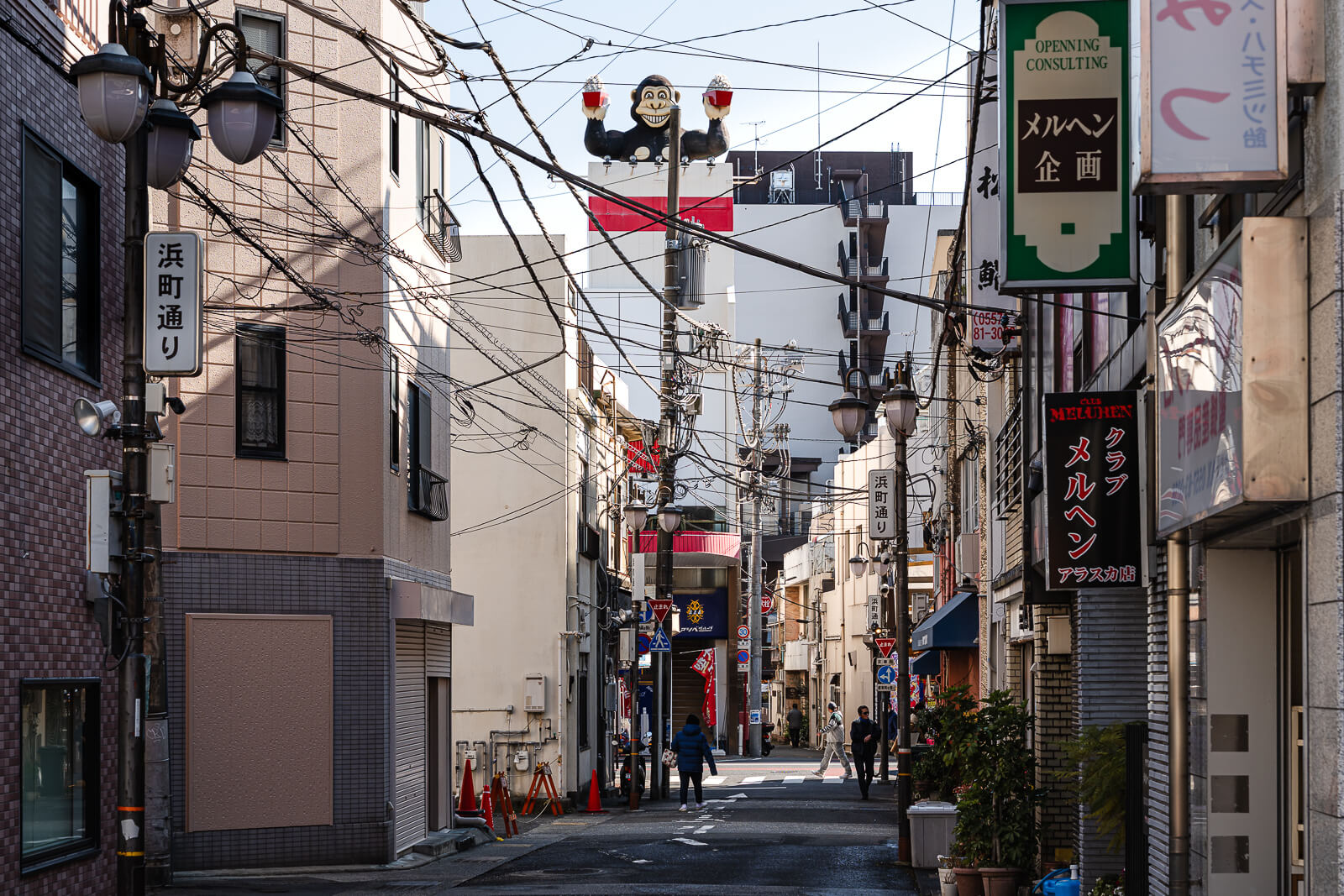 Lower-town side street in Atami on the walk from the station area toward the waterfront.