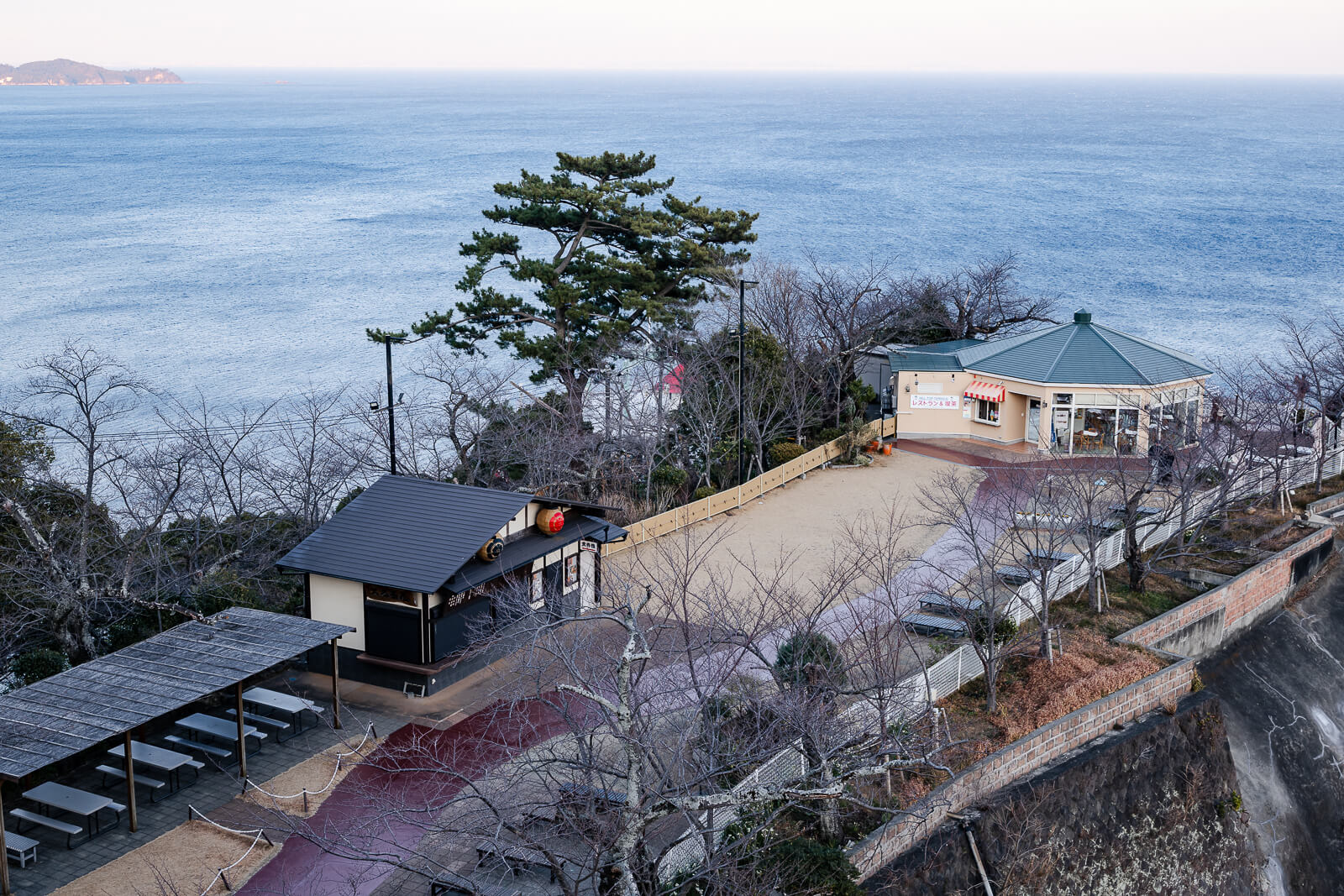 Park and café area at the base of Atami Castle overlooking the coastline in Atami