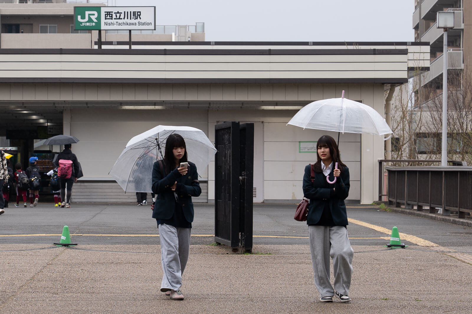 girl using phone outside train station affiliate placement eSIM