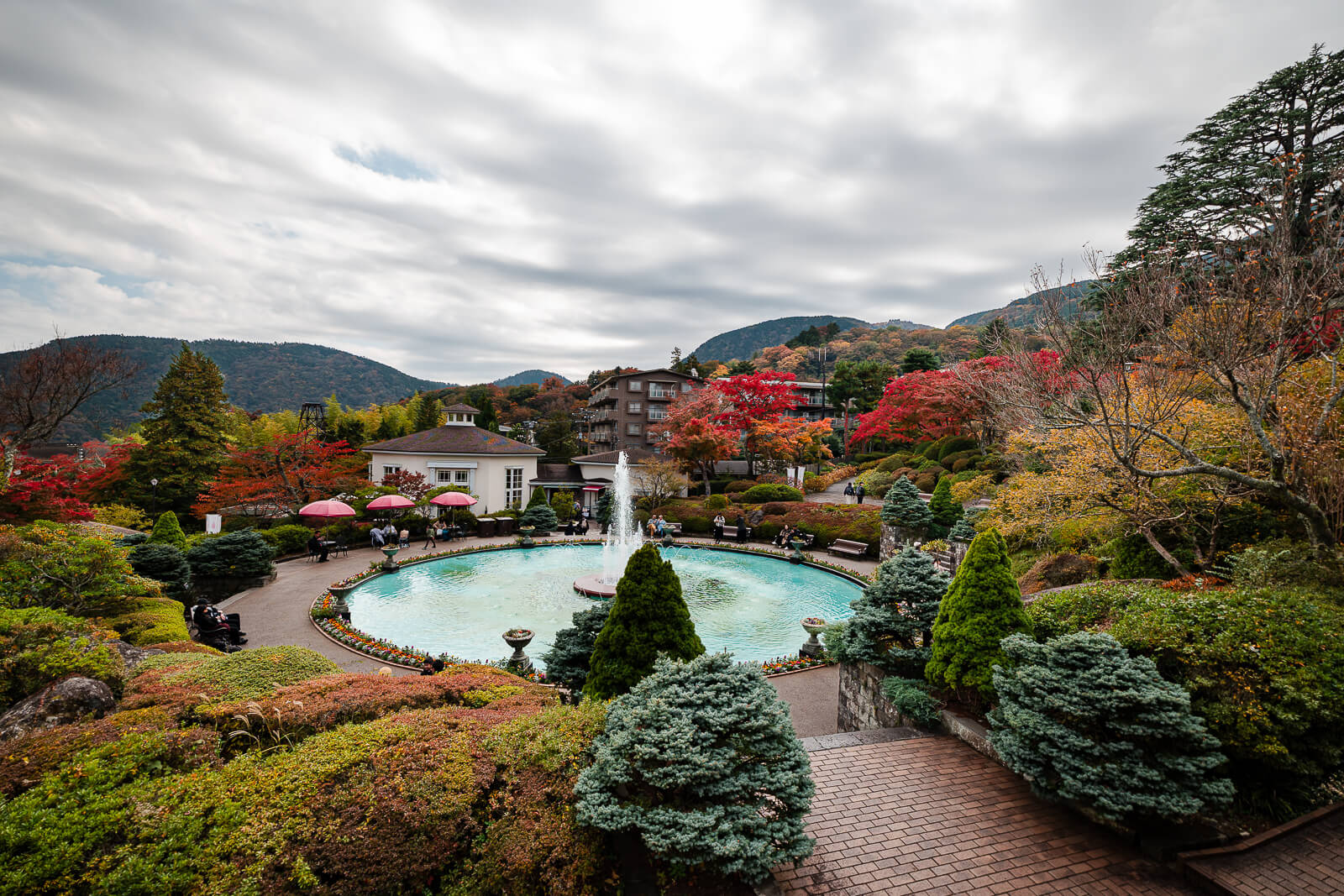 Central fountain surrounded by autumn foliage and landscaped gardens at Gora Park in Hakone