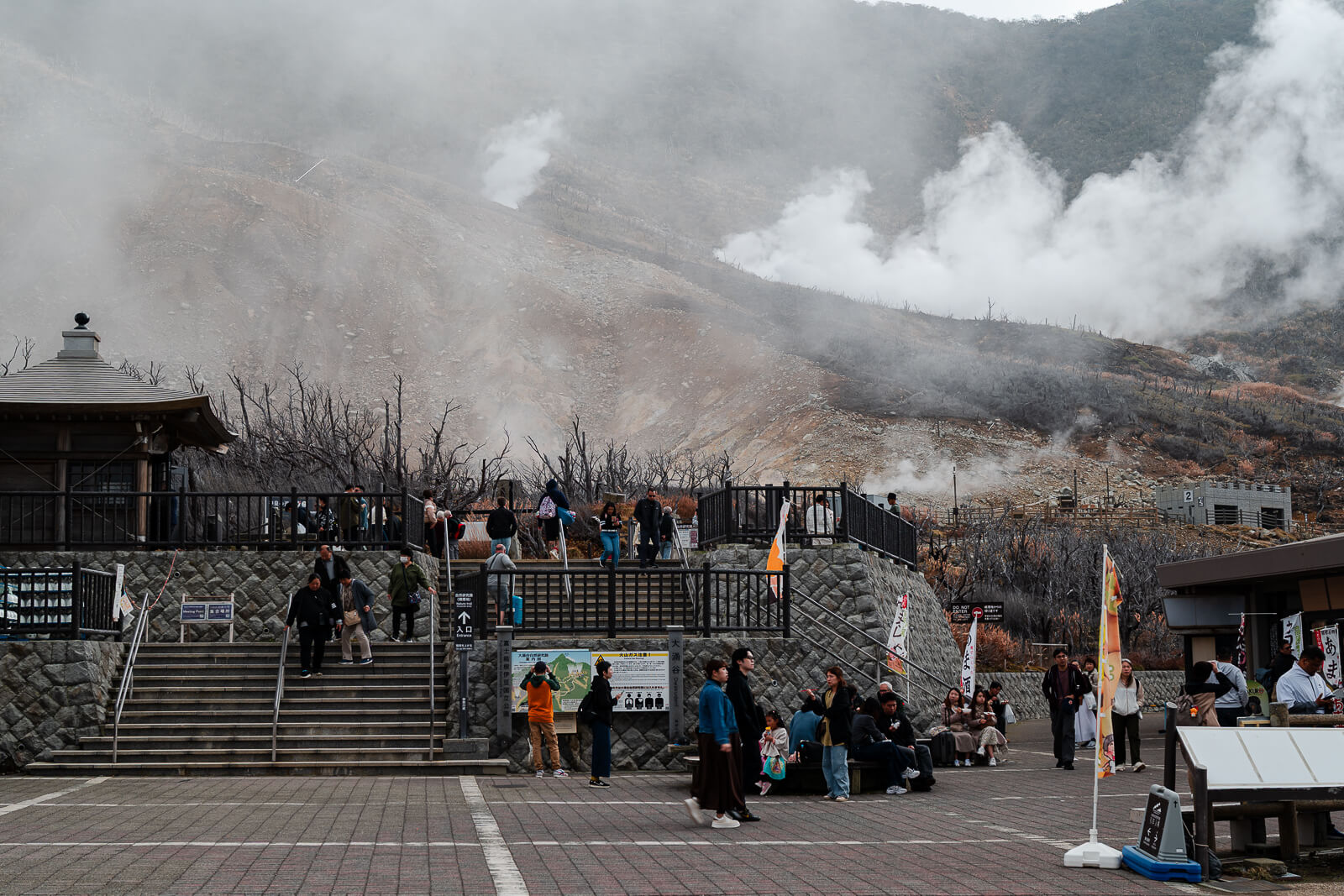 Visitors gathered along the Owakudani walkway overlooking steam vents and open valley
