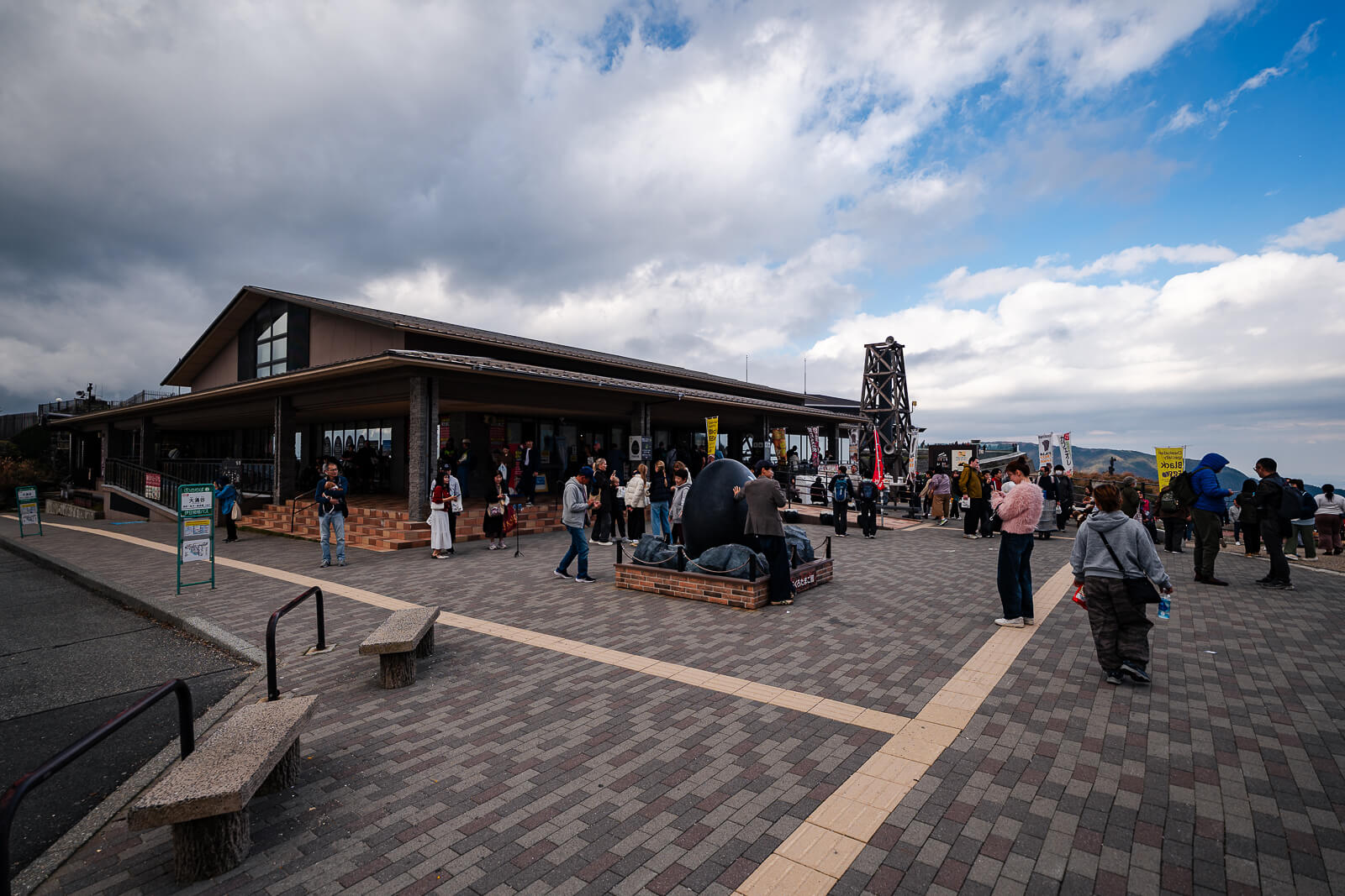 Owakudani arrival area with visitors walking toward the viewing paths and facilities