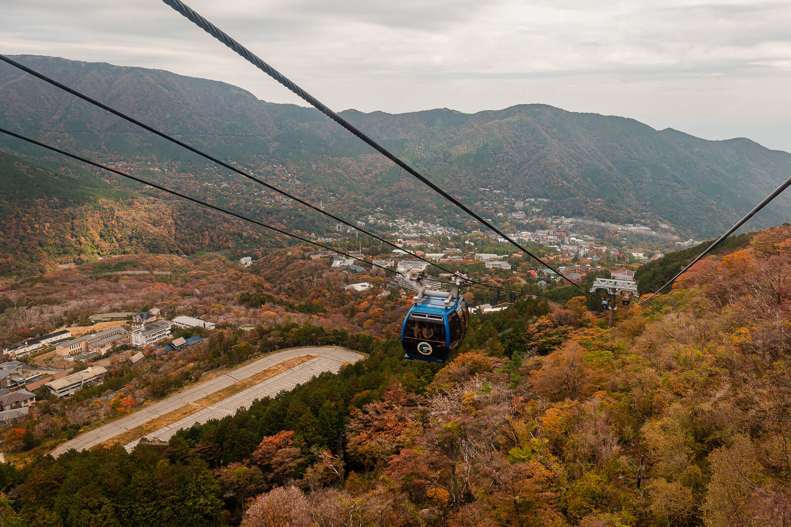 Hakone Ropeway gondola above autumn-colored mountains between Owakudani and Sounzan