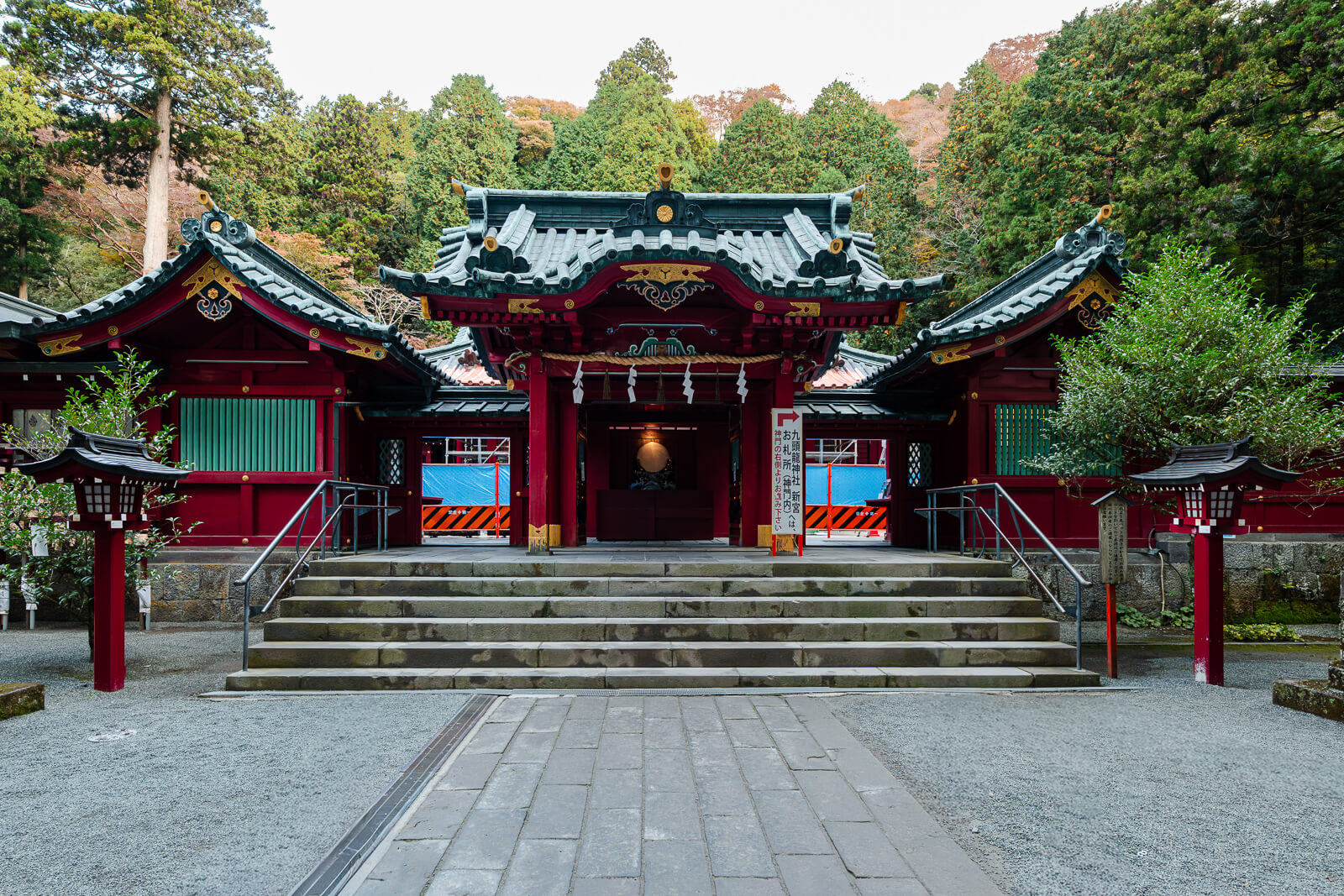Main gate and stone entrance steps beneath the trees at Hakone Shrine in Motohakone