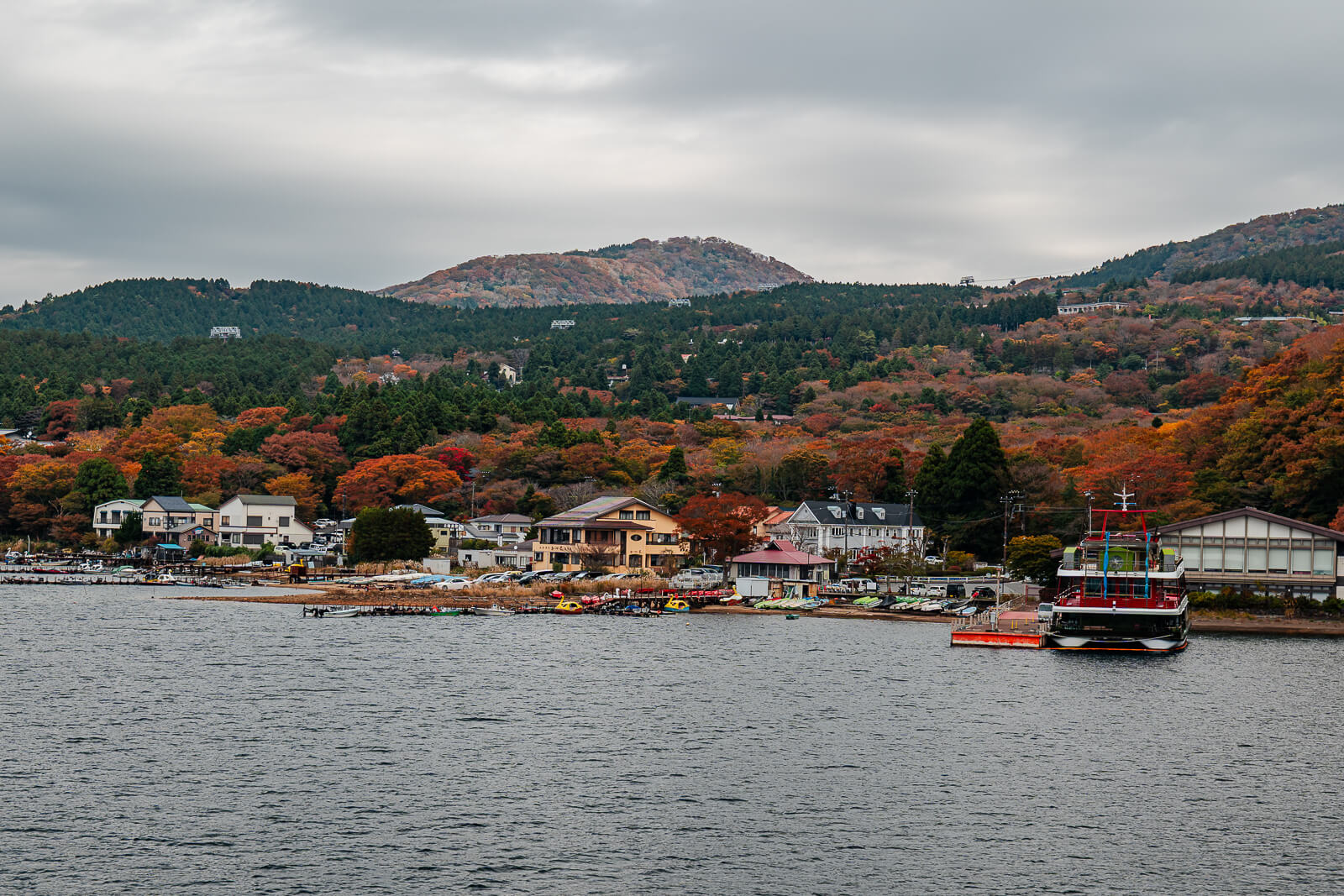 Togendai harbor and Lake Ashi backed by autumn-colored mountains in Hakone