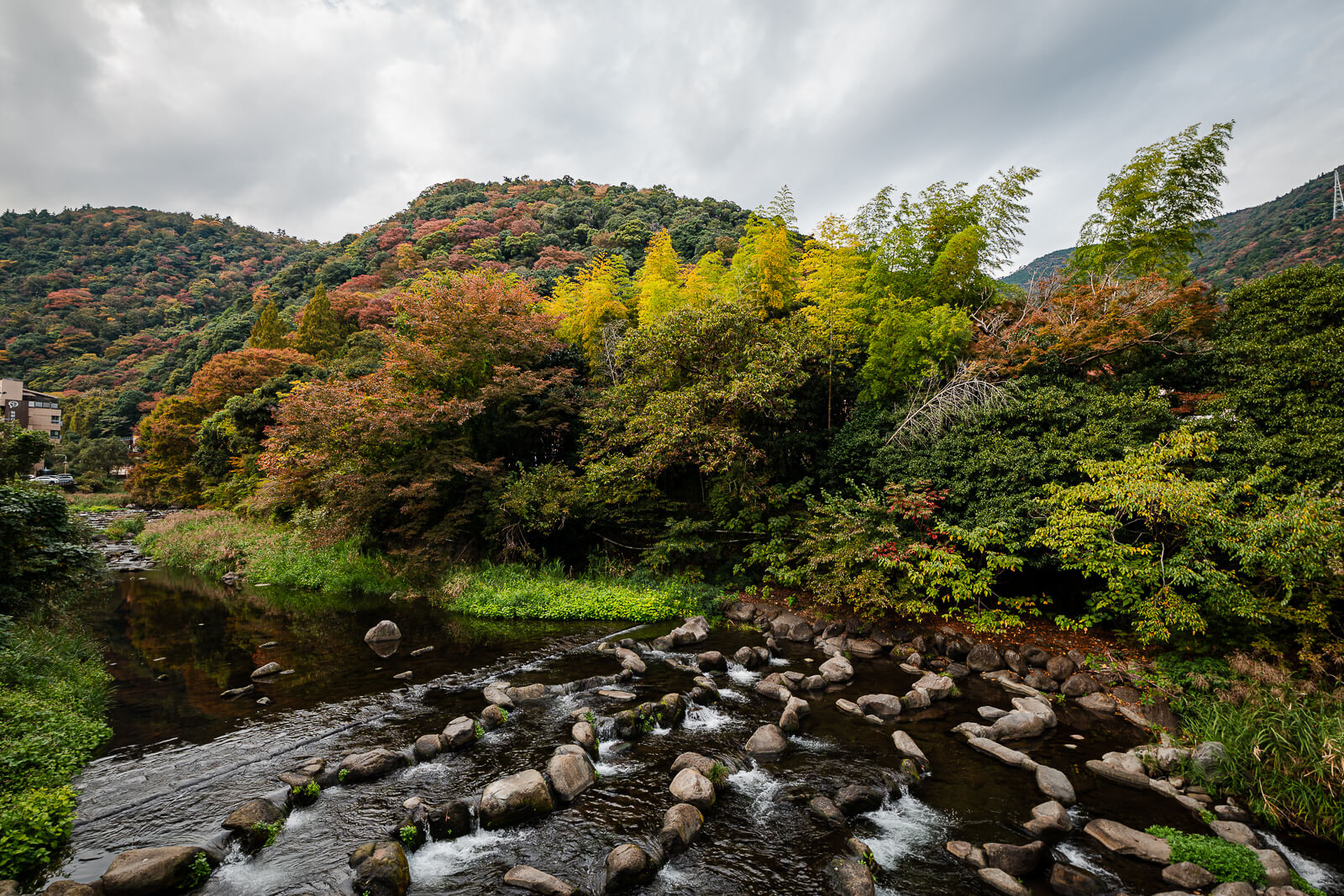 Autumn foliage covering the hills beside the Hayakawa River in Hakone-Yumoto