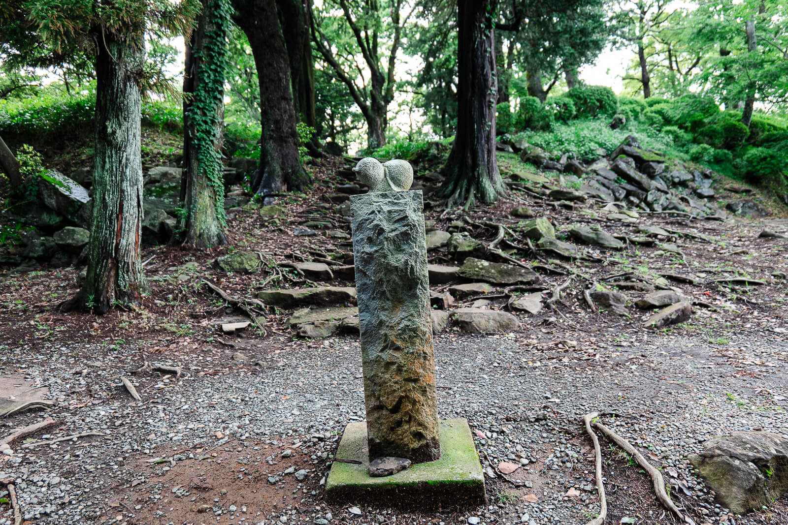 Stone marker standing among trees at Ishigakiyama Castle Ruins in Odawara