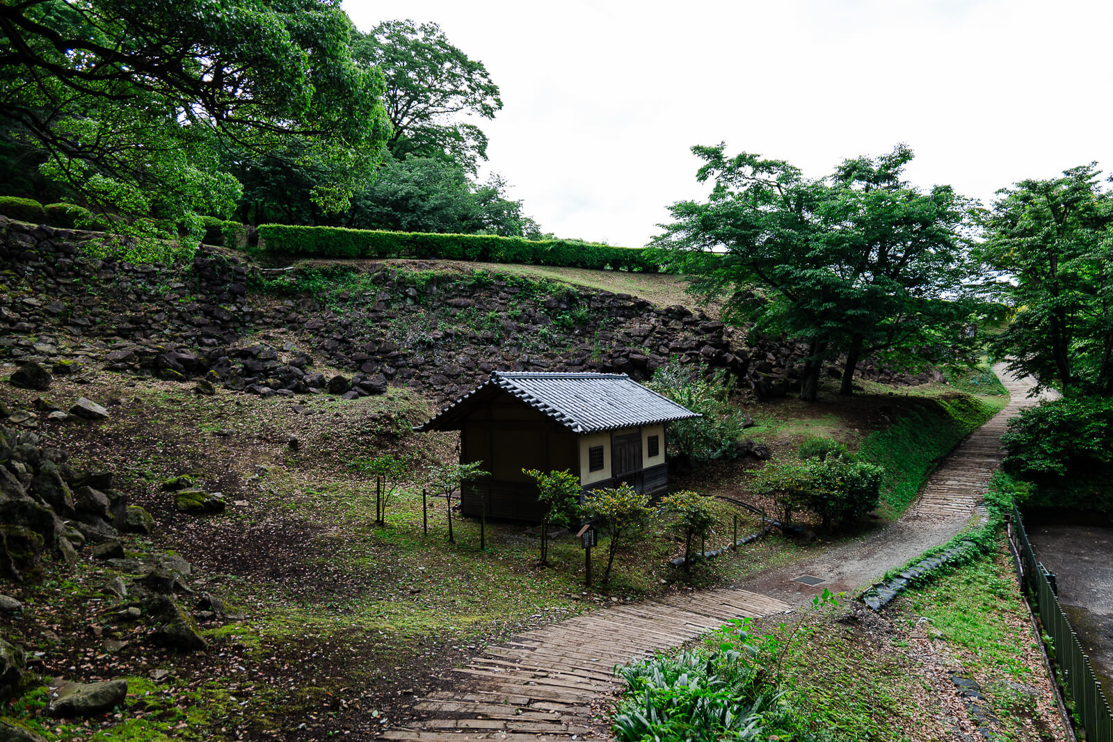 Path and small structure among the ruins at Ishigakiyama Castle Ruins in Odawara