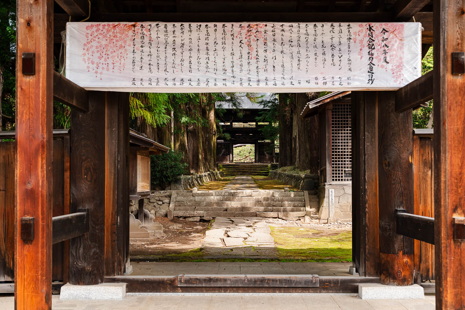 View through a wooden gate at Jiunji Temple in Shimosuwa