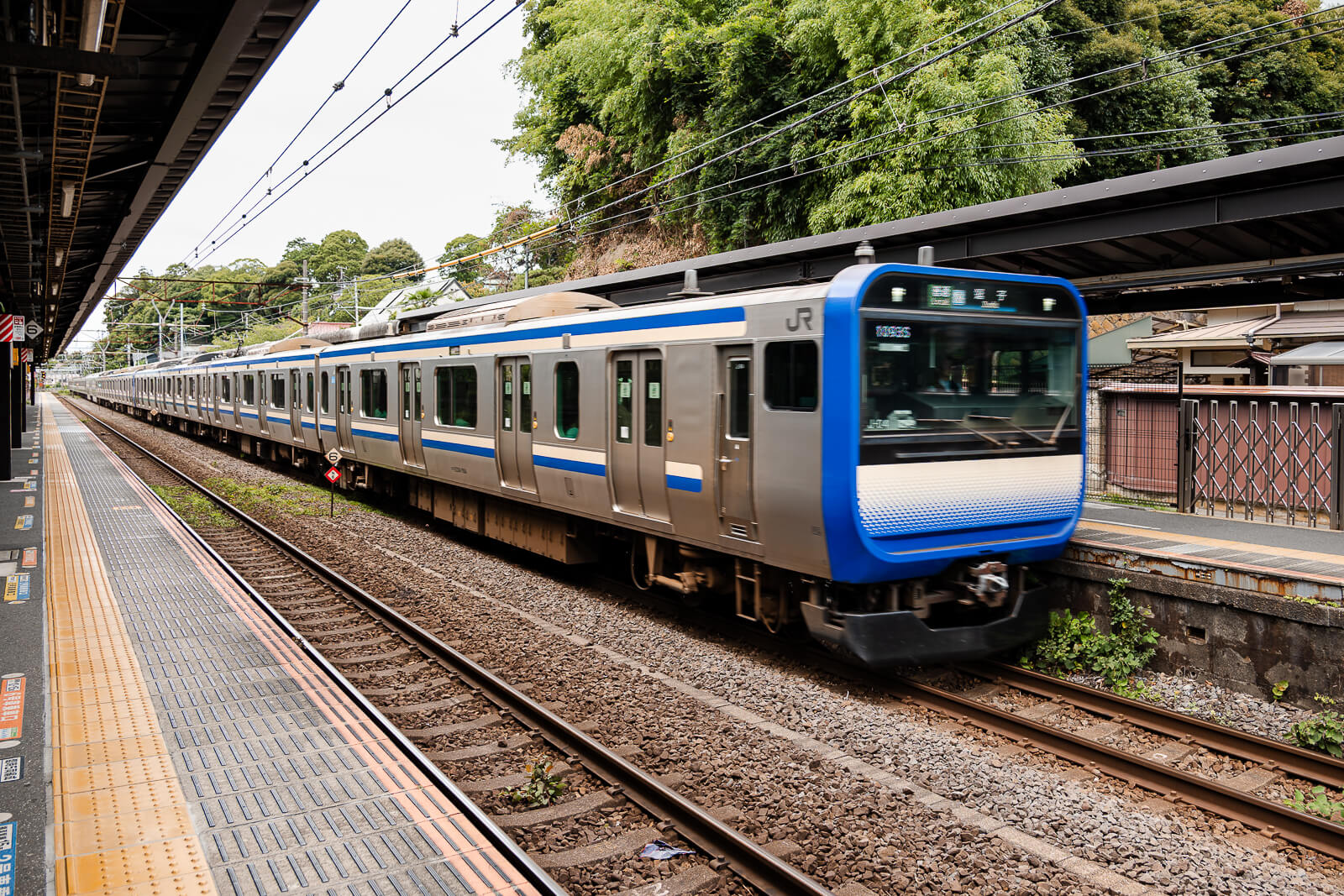 JR Yokosuka Line train passing the platform at Kita-Kamakura Station.