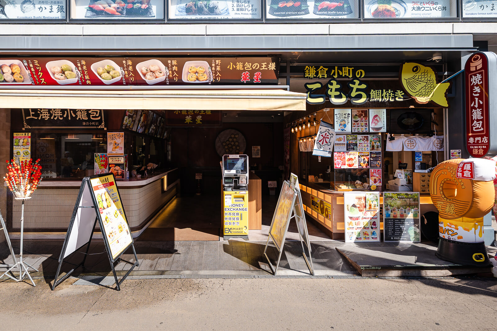 Restaurant menu displays with photos along Komachi-dori street
