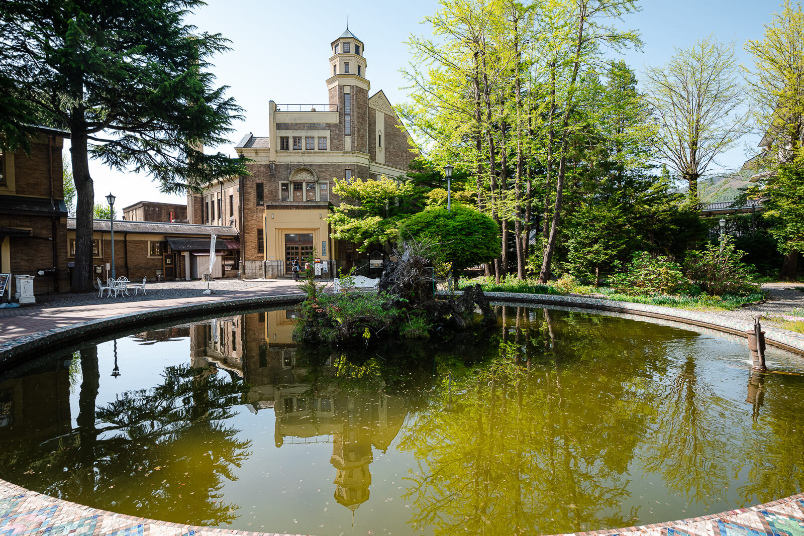 Courtyard pond beside Katakurakan public bathhouse near Lake Suwa