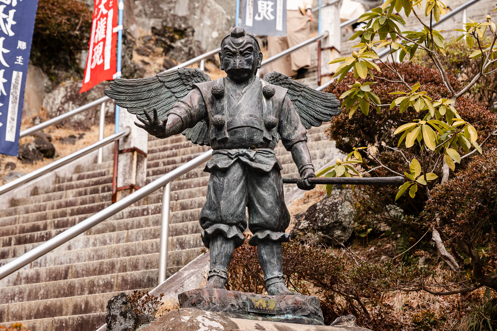 Karasu Tengu statue standing beside the stone steps to Hansobo Shrine at Kencho-ji Temple