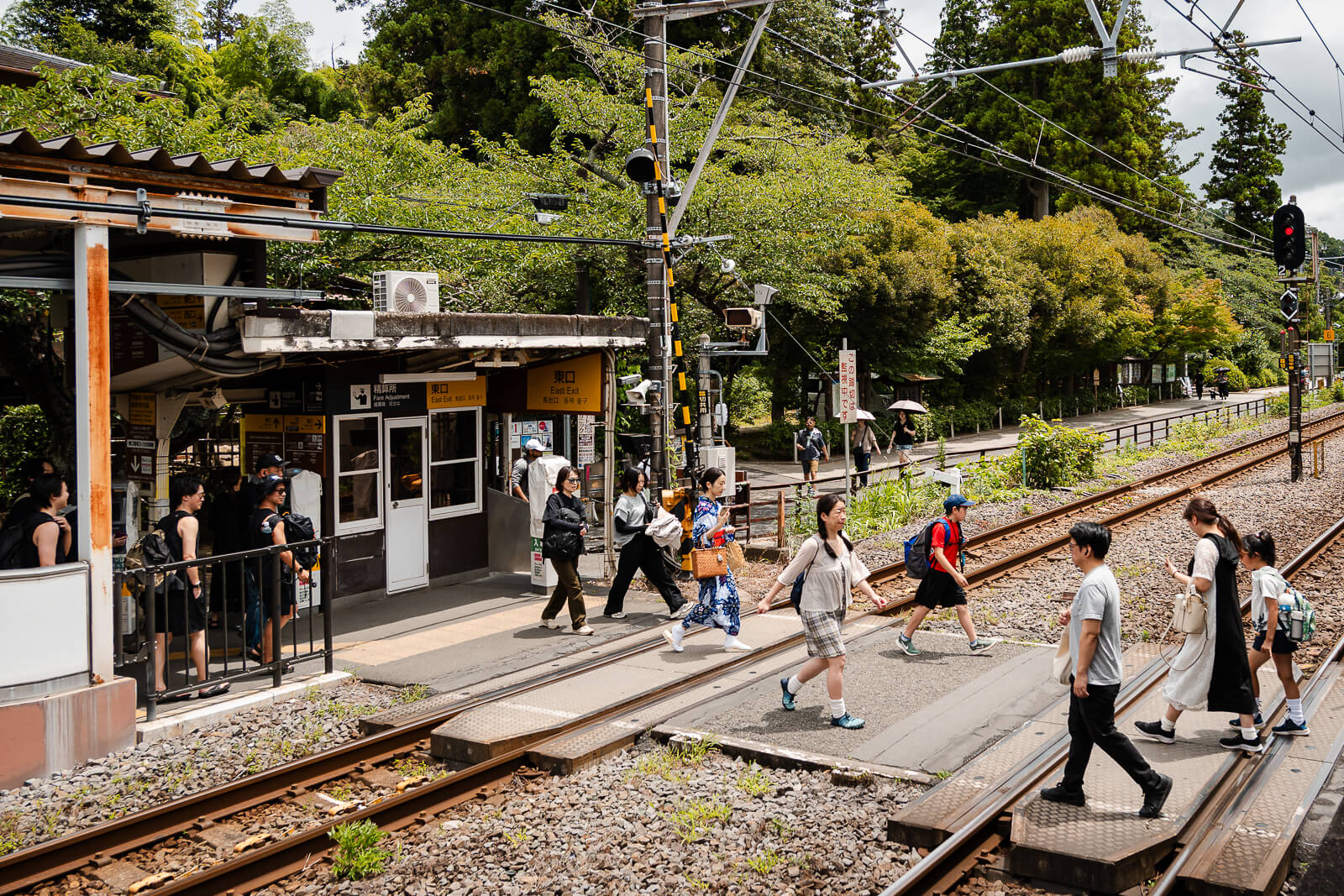 Passengers crossing the tracks toward the East Exit at Kita-Kamakura Station