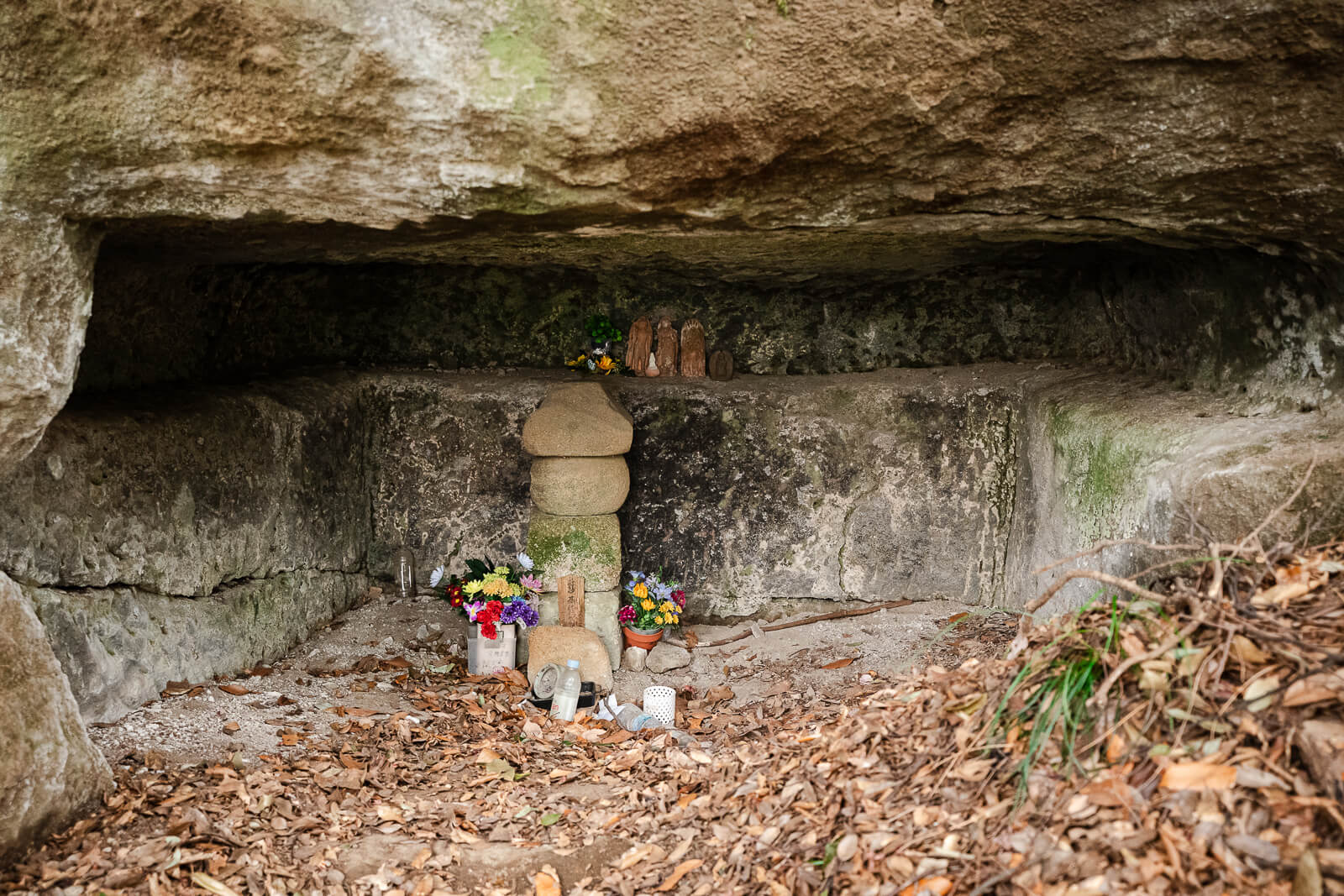 Stone Buddhist figures and offerings inside a Hyakuhachi Yagura burial chamber