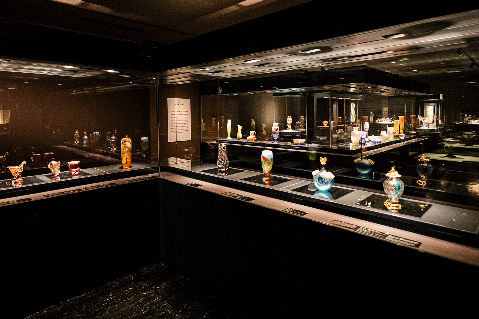 Glass art displays arranged throughout a gallery at Kitazawa Museum of Art