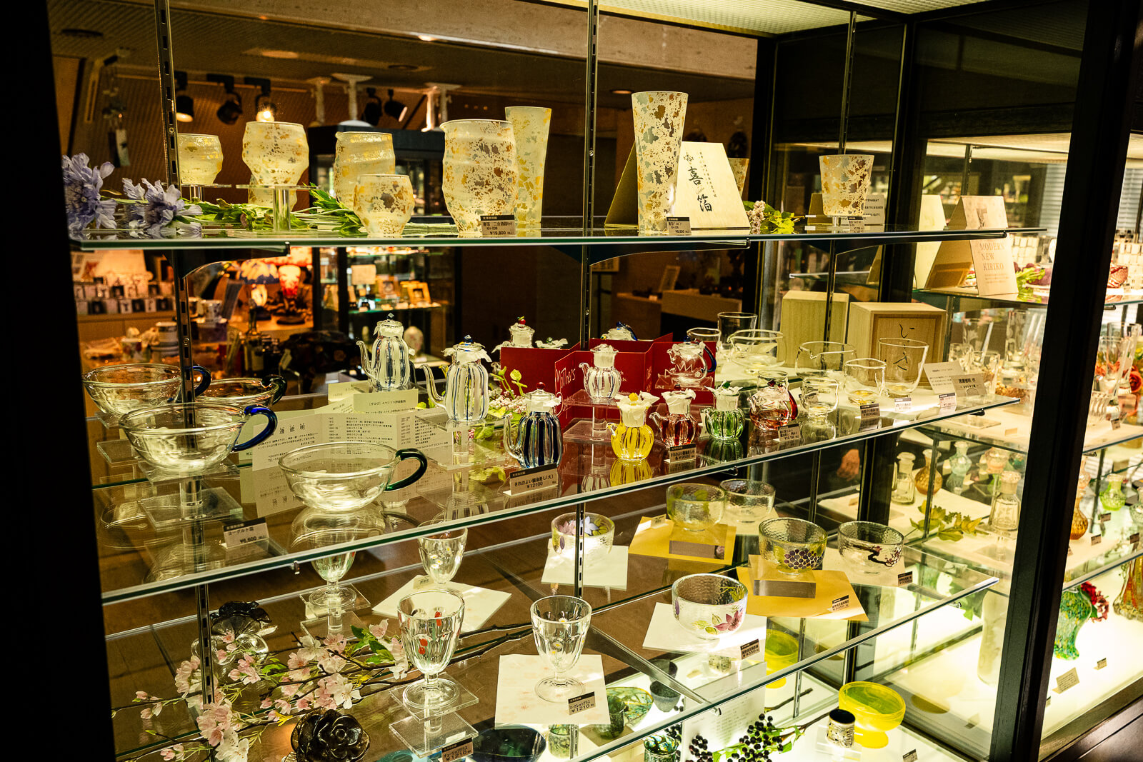 Display case featuring decorative glass art and museum merchandise at Kitazawa Museum of Art