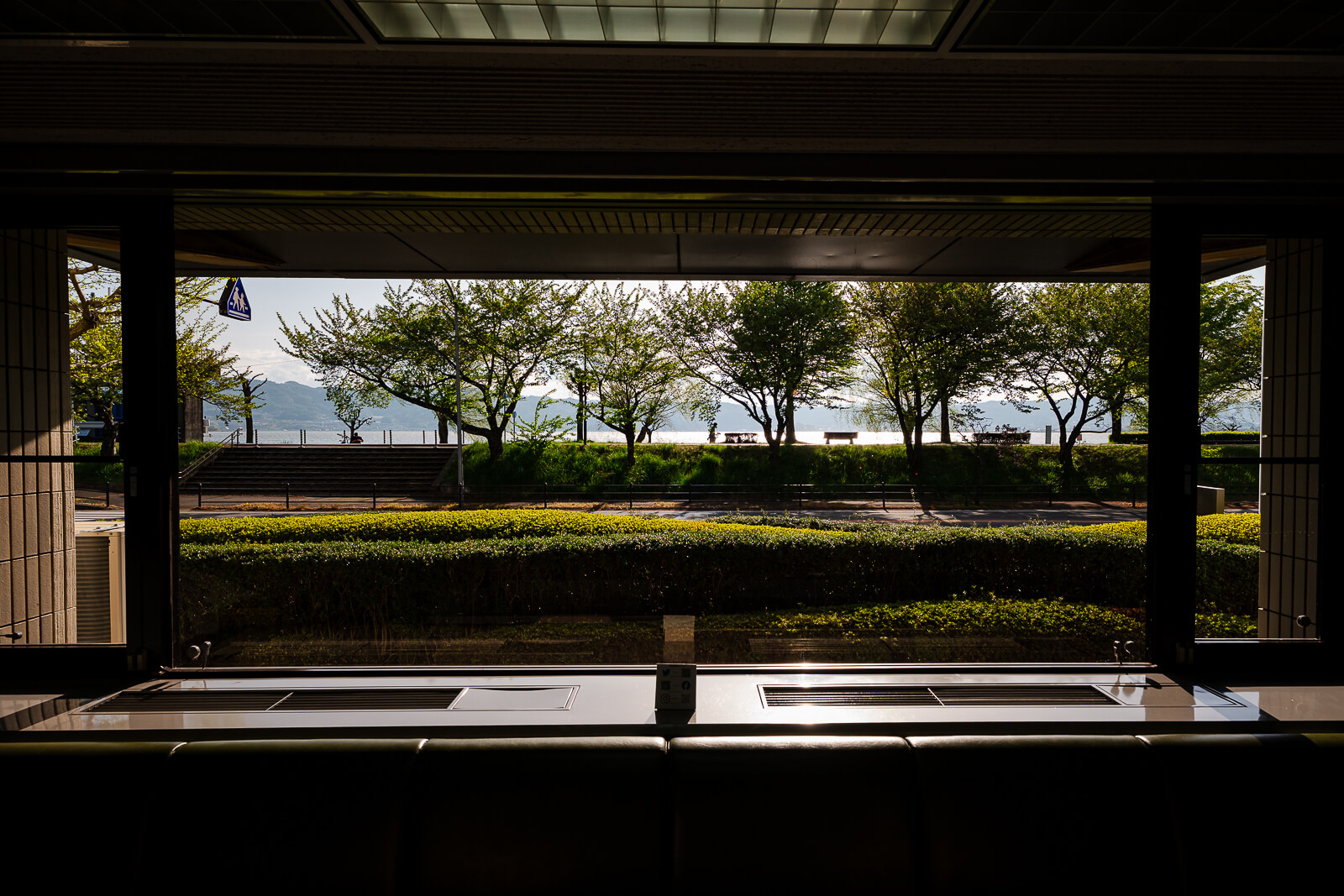 Lake Suwa viewed through large museum windows near the waterfront