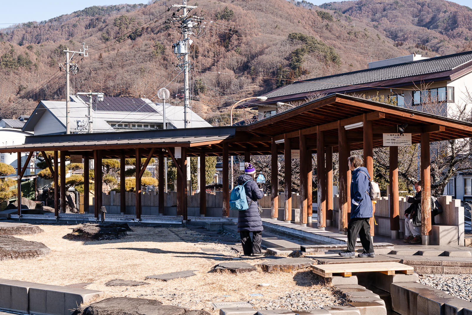 Visitors gathered near the footbath pavilion at Lake Suwa Geyser Center