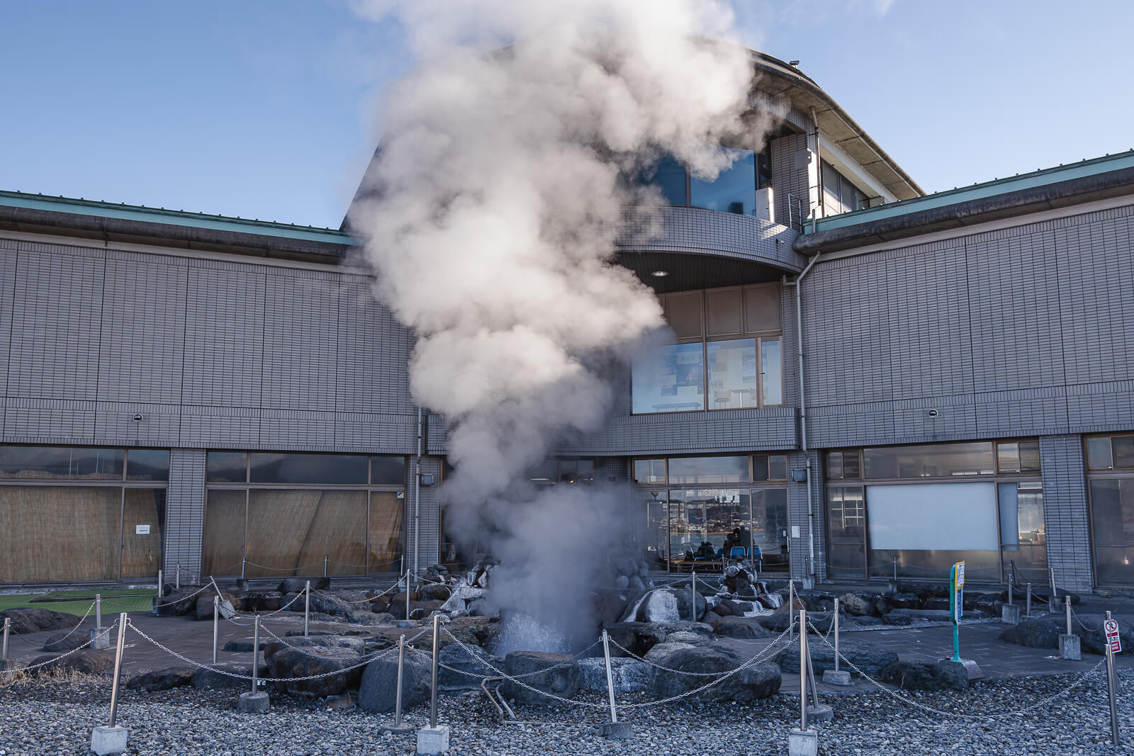Lake Suwa Geyser Center building with steam rising from the geyser area