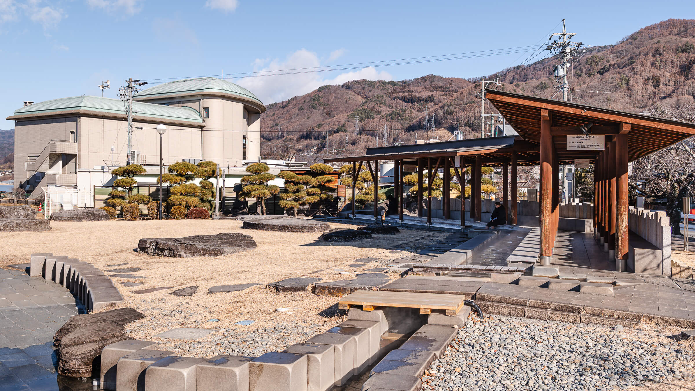 Lake Suwa Geyser Center footbath pavilion in Kamisuwa with surrounding mountains in Suwa, Nagano