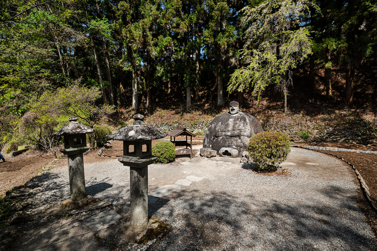Manji Stone Buddha with stone lanterns in Shimosuwa, Nagano Prefecture.